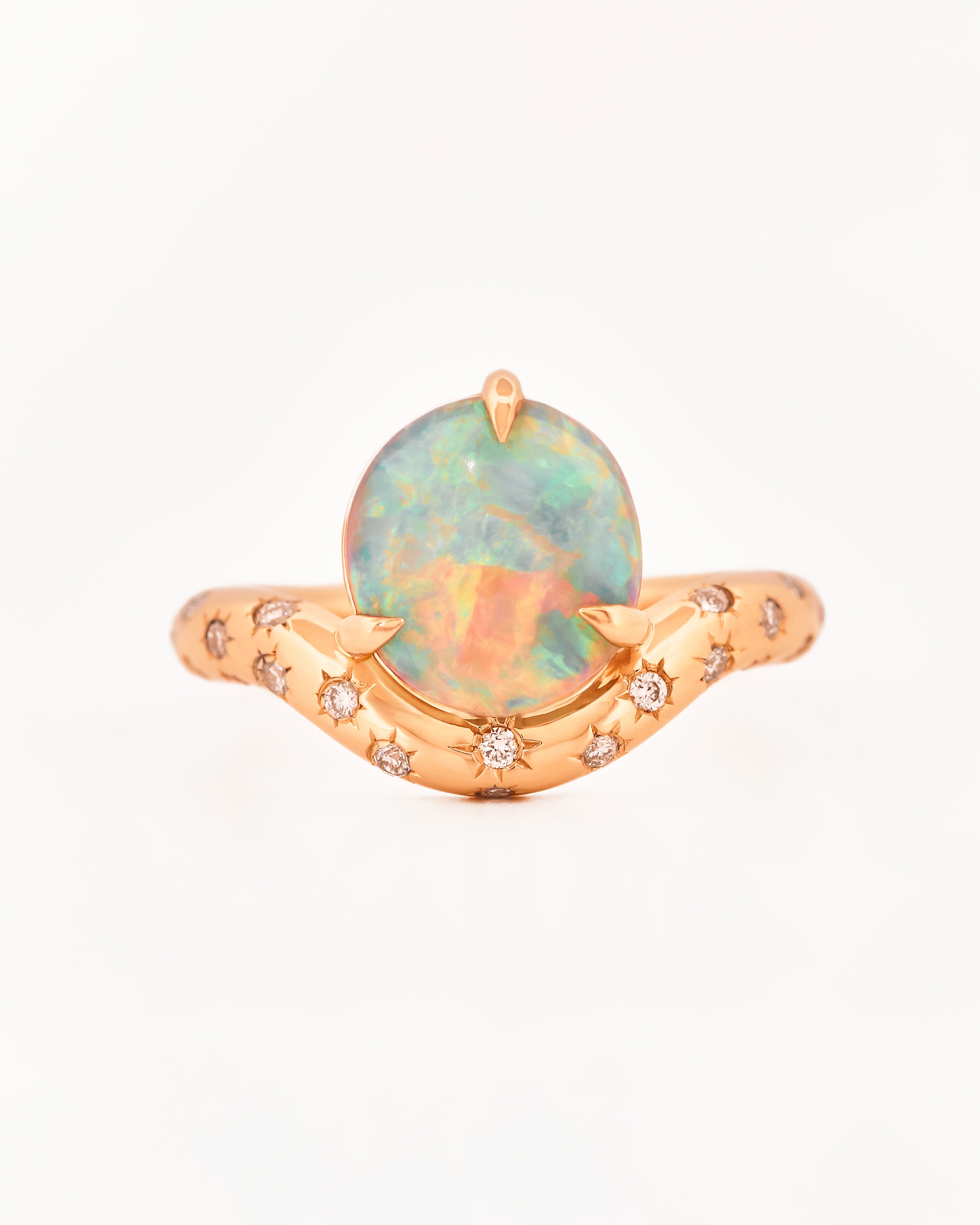Rose Gold ring with an australian opal centrestone on a white background.