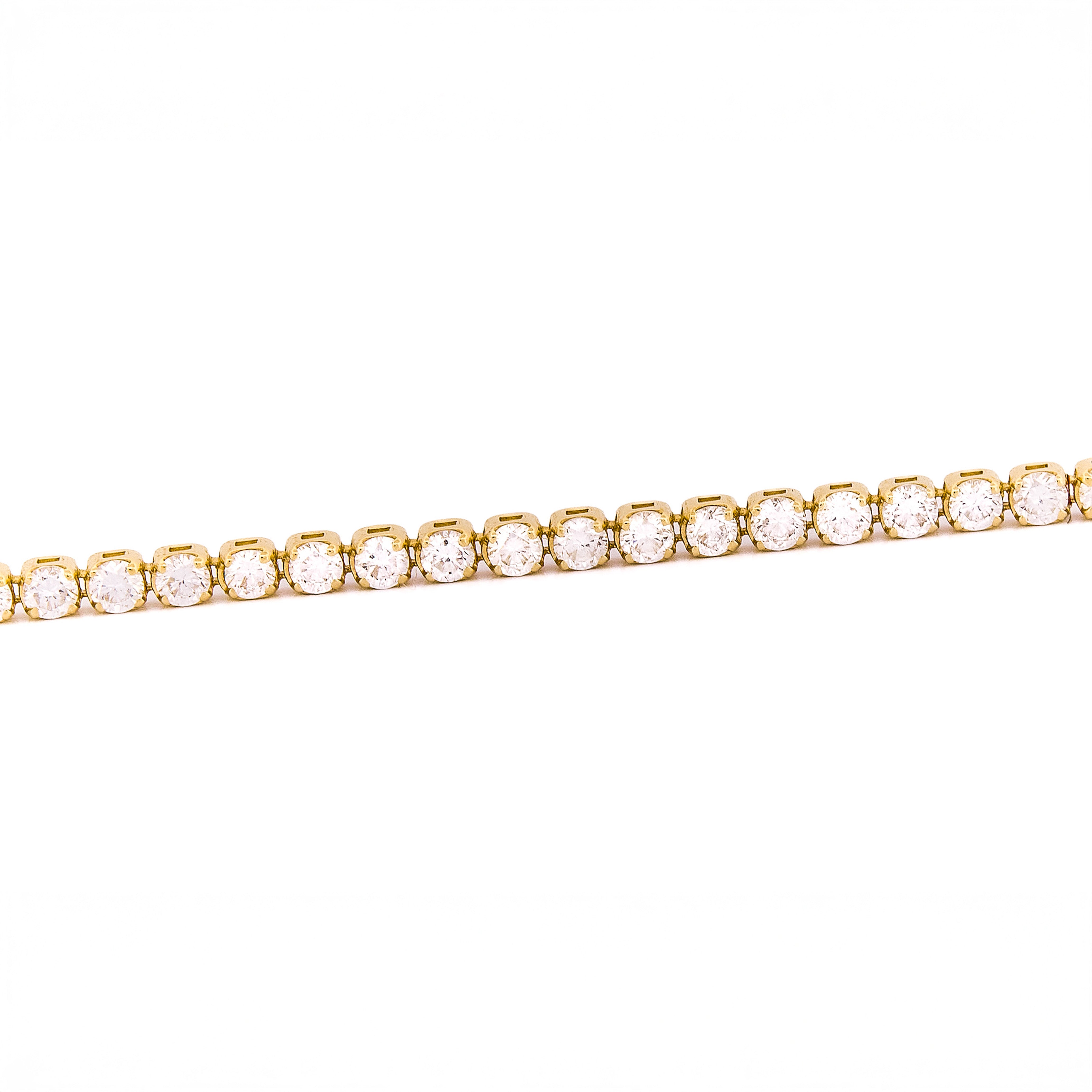 Gold bracelet with diamonds on a white background