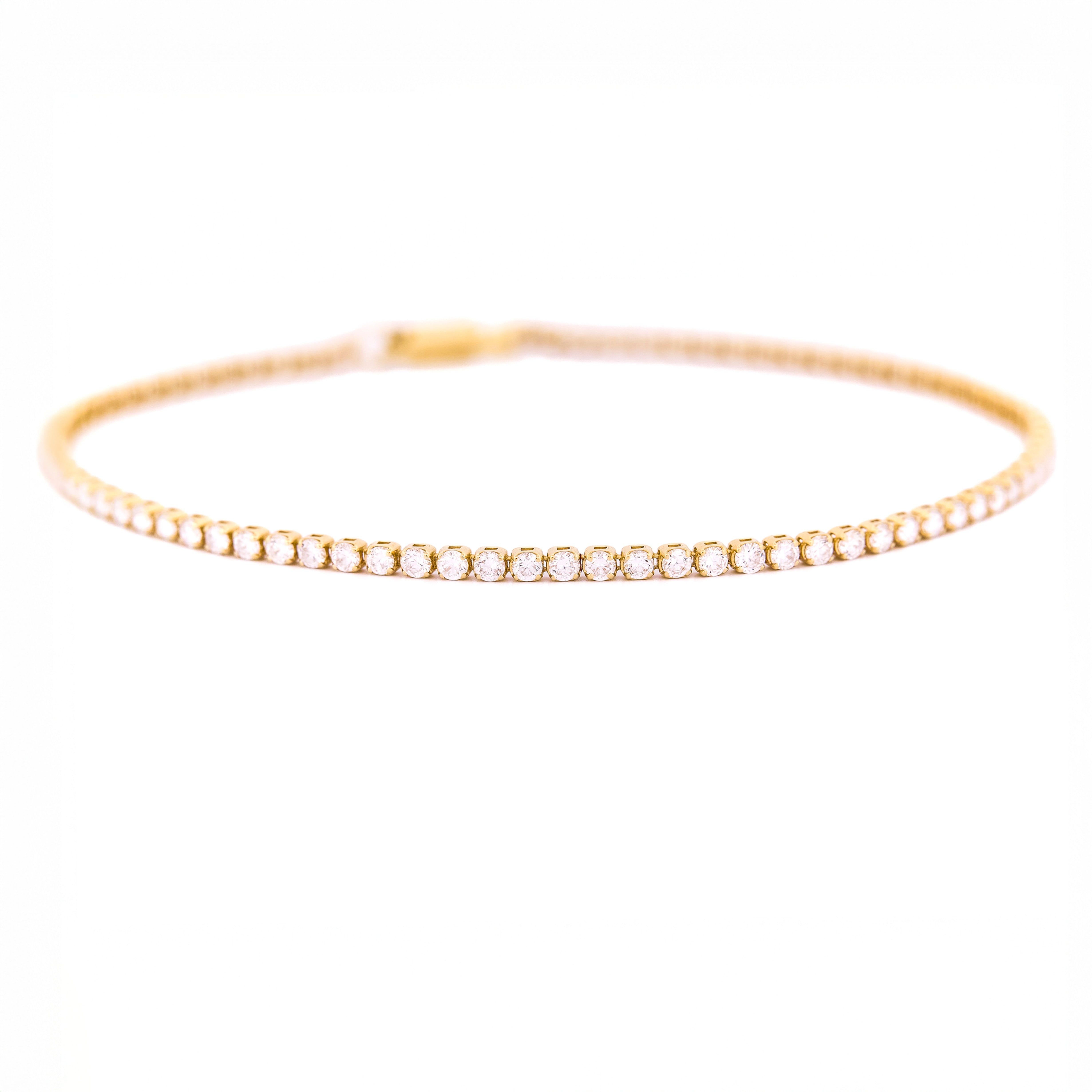 Gold bracelet with diamonds on a white background