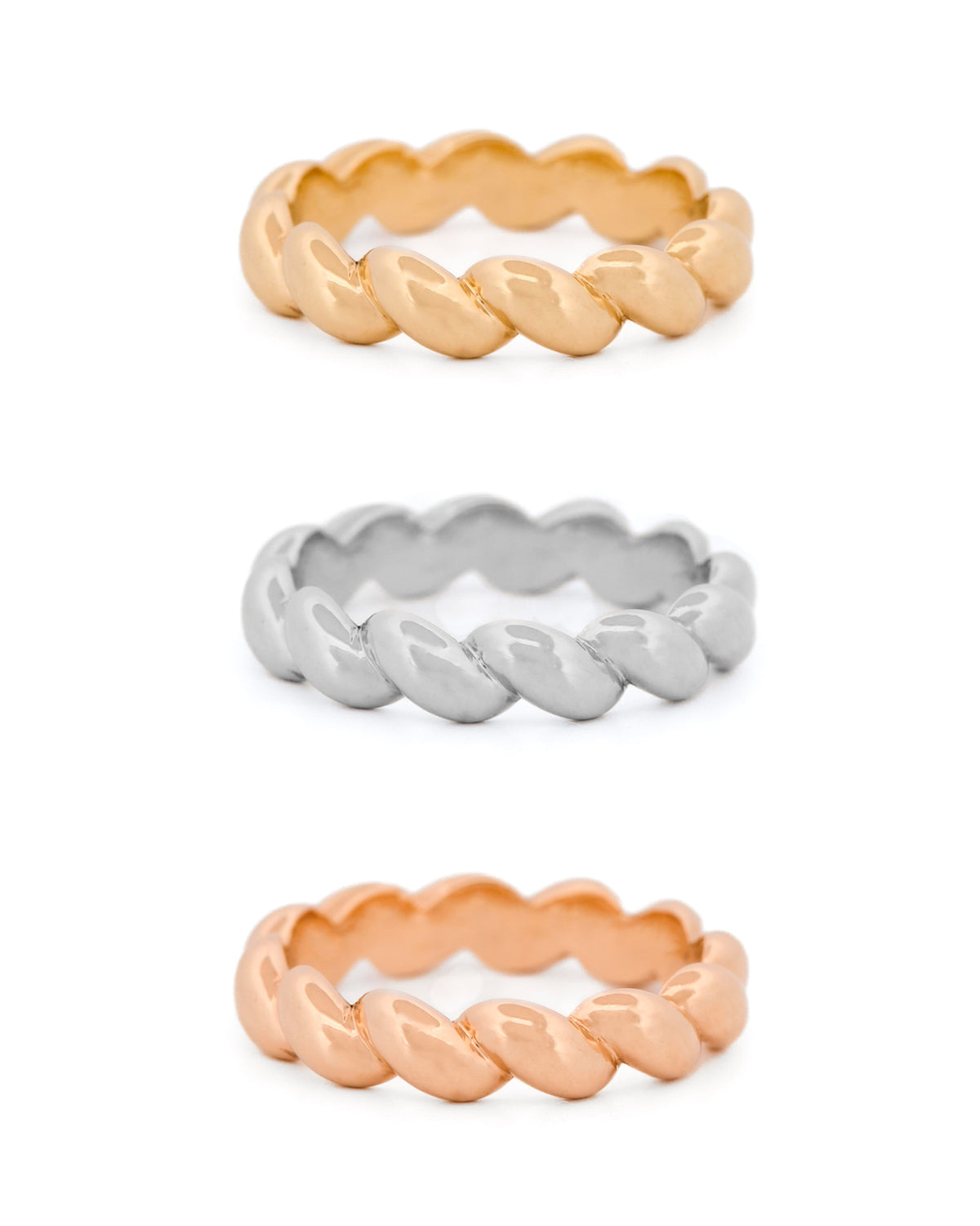 Three braided rings in yellow gold, rose gold, and white gold on a white background