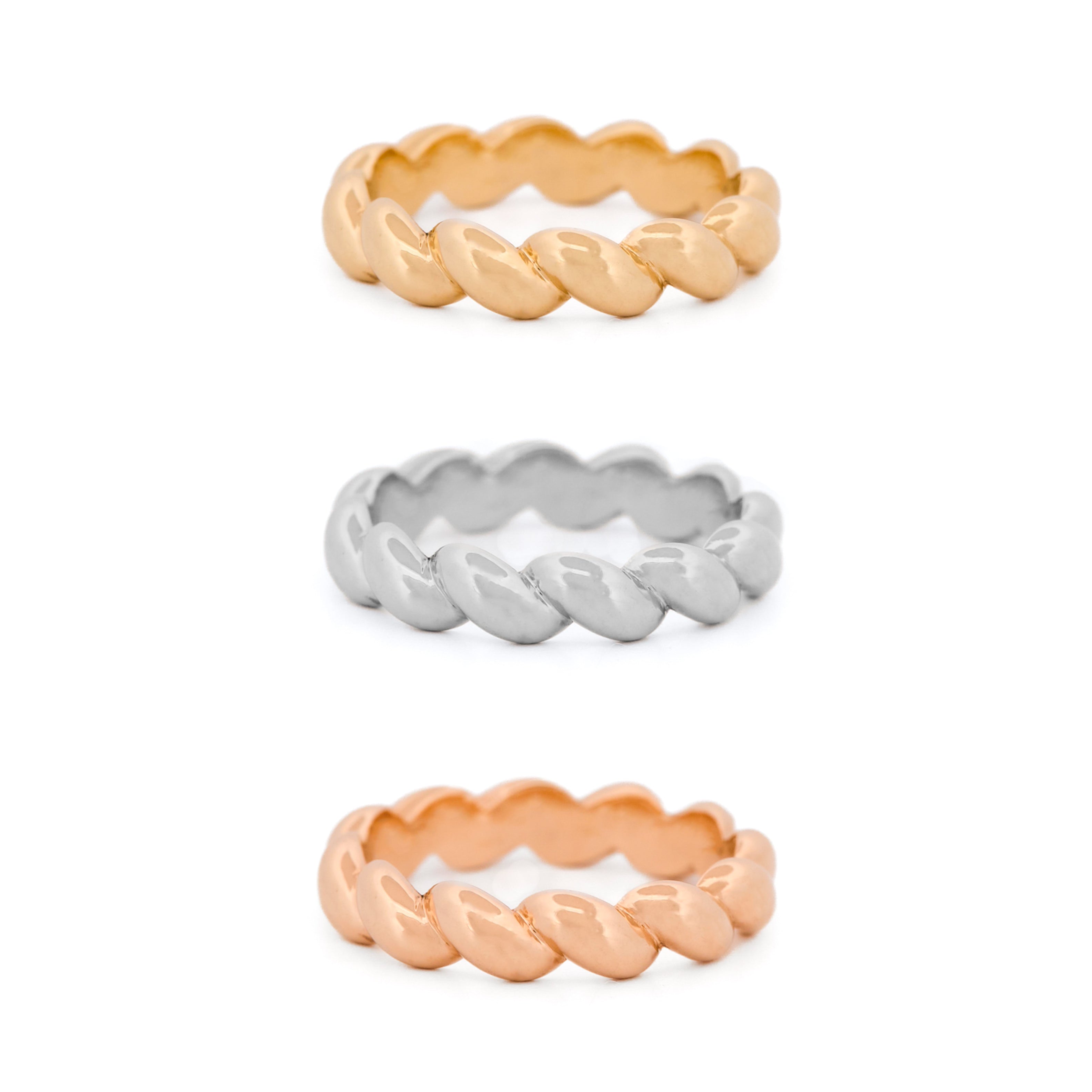 Three braided rings in yellow gold, rose gold, and white gold on a white background