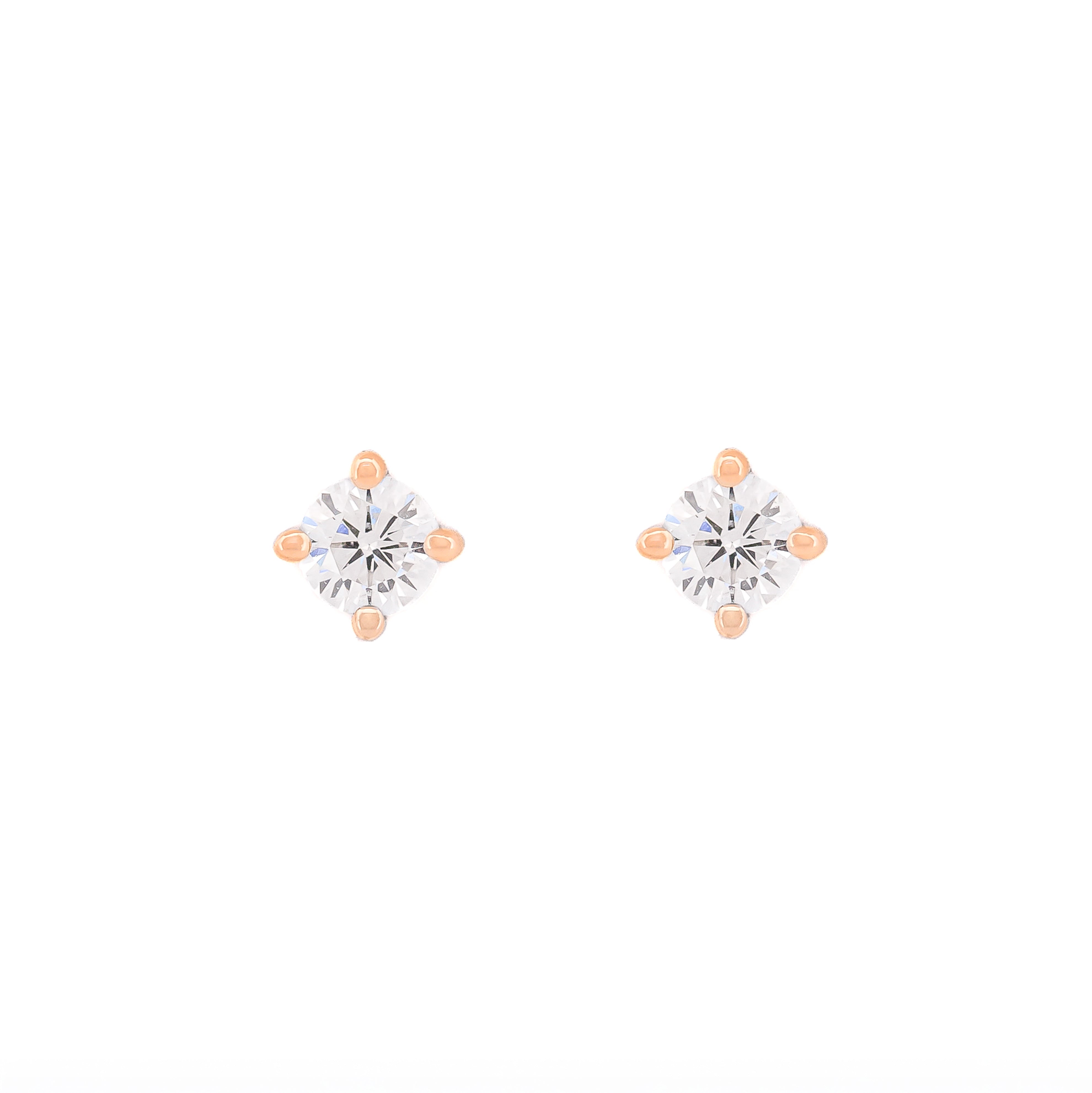 Pair of diamond stud earrings on a white background