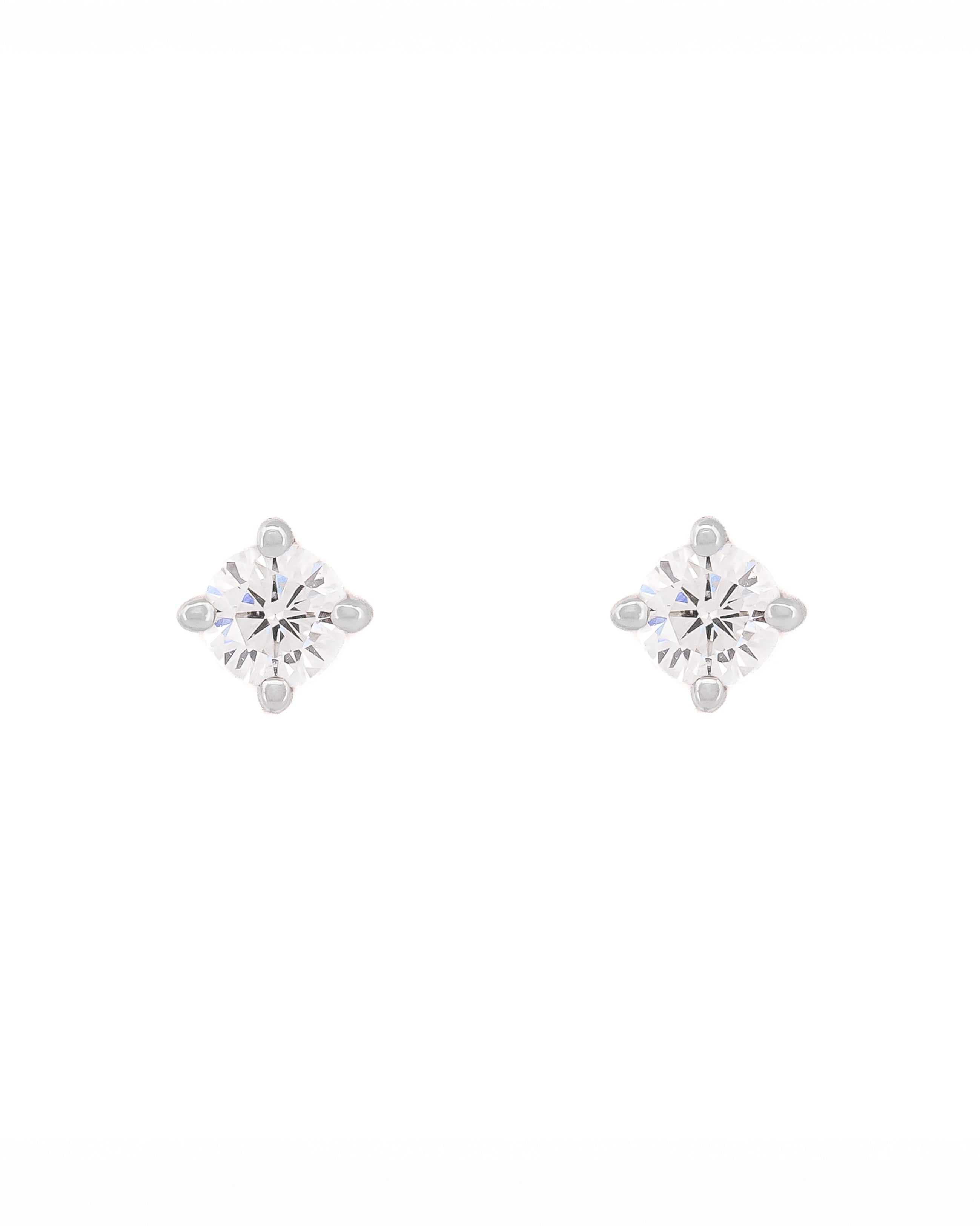 Pair of snowflake-shaped silver earrings on a white background