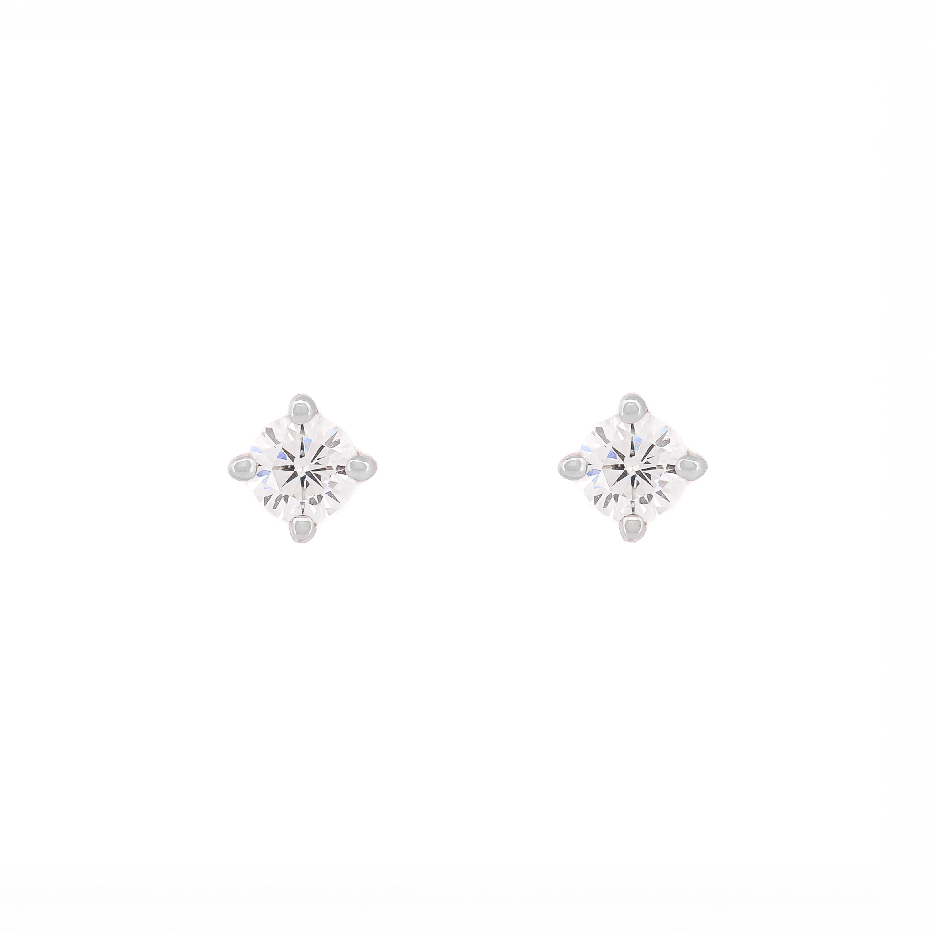 Pair of snowflake-shaped silver earrings on a white background