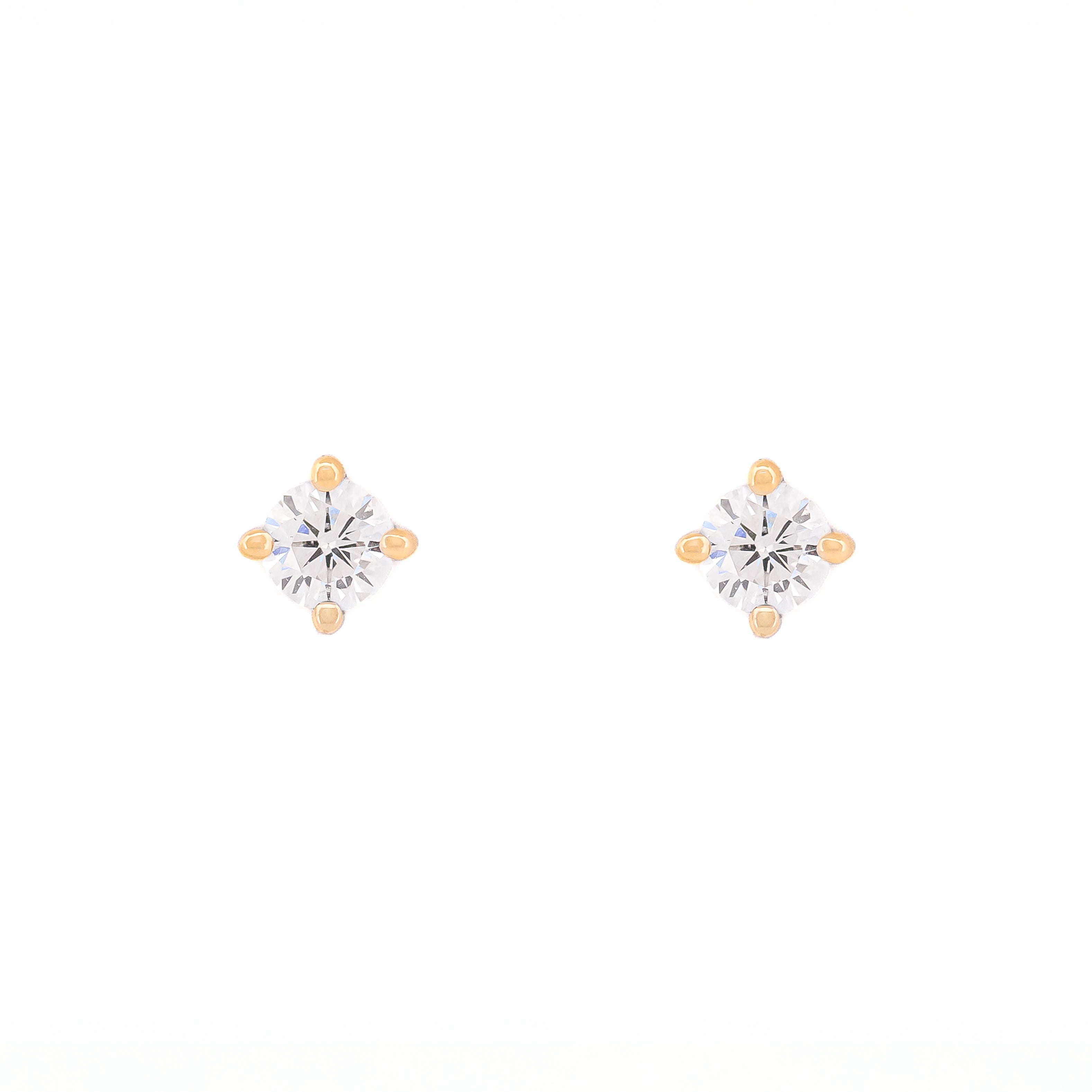 Pair of diamond stud earrings on a white background