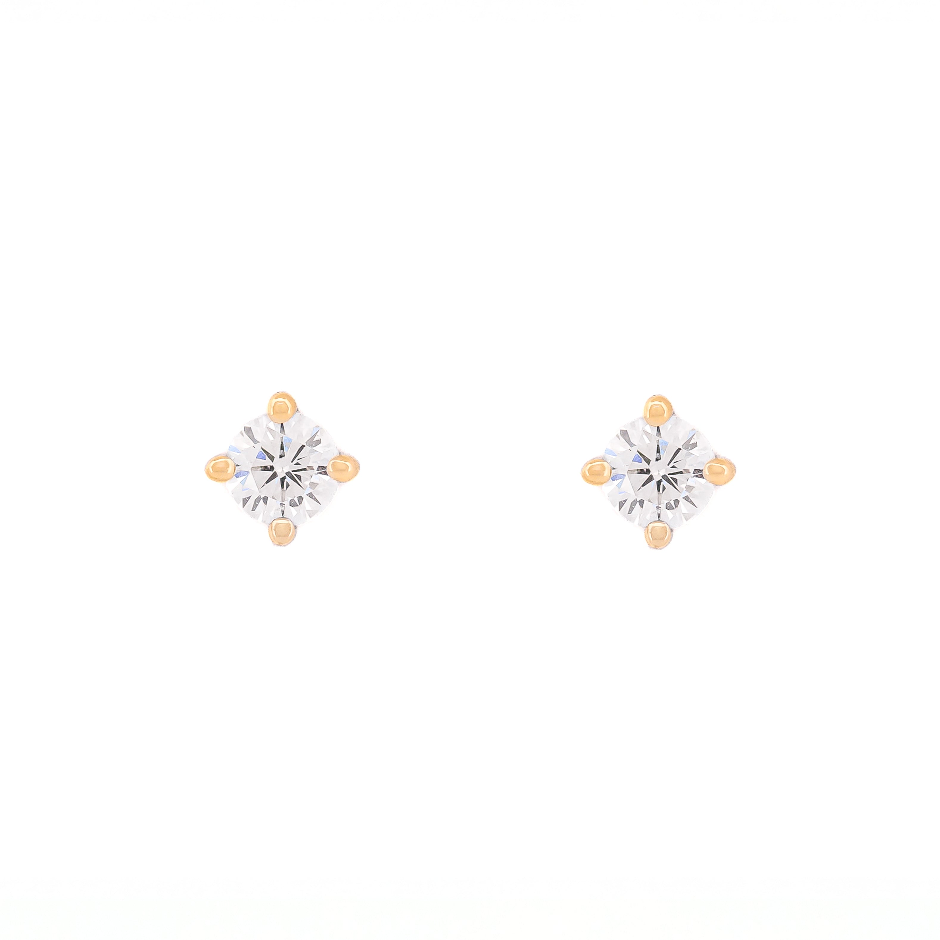Pair of diamond stud earrings on a white background