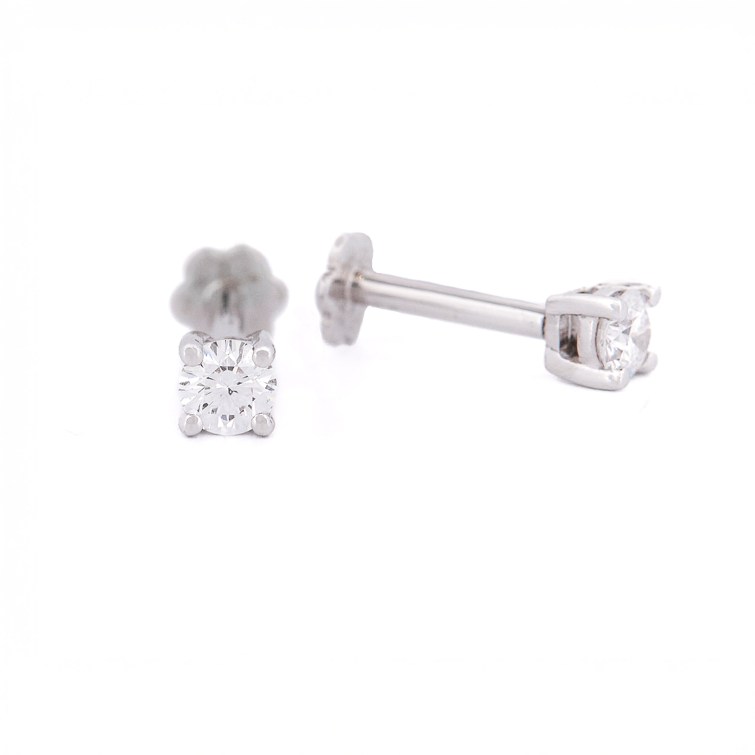 Pair of diamond stud earrings on a white background