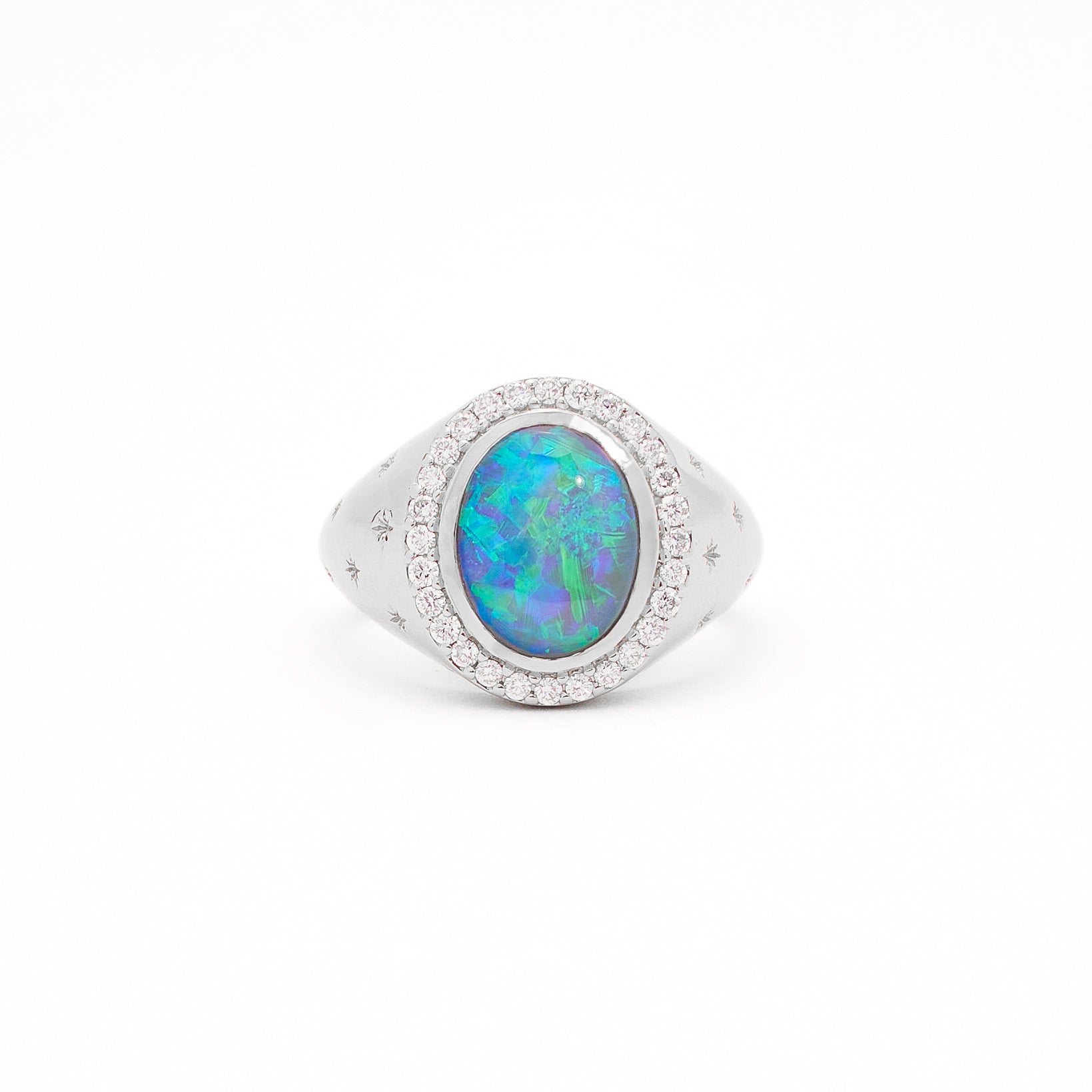 An Australian Opal and Diamonds Signet Ring in white gold with the opal as the centrepiece, surrounded by white diamonds and set on a white background.