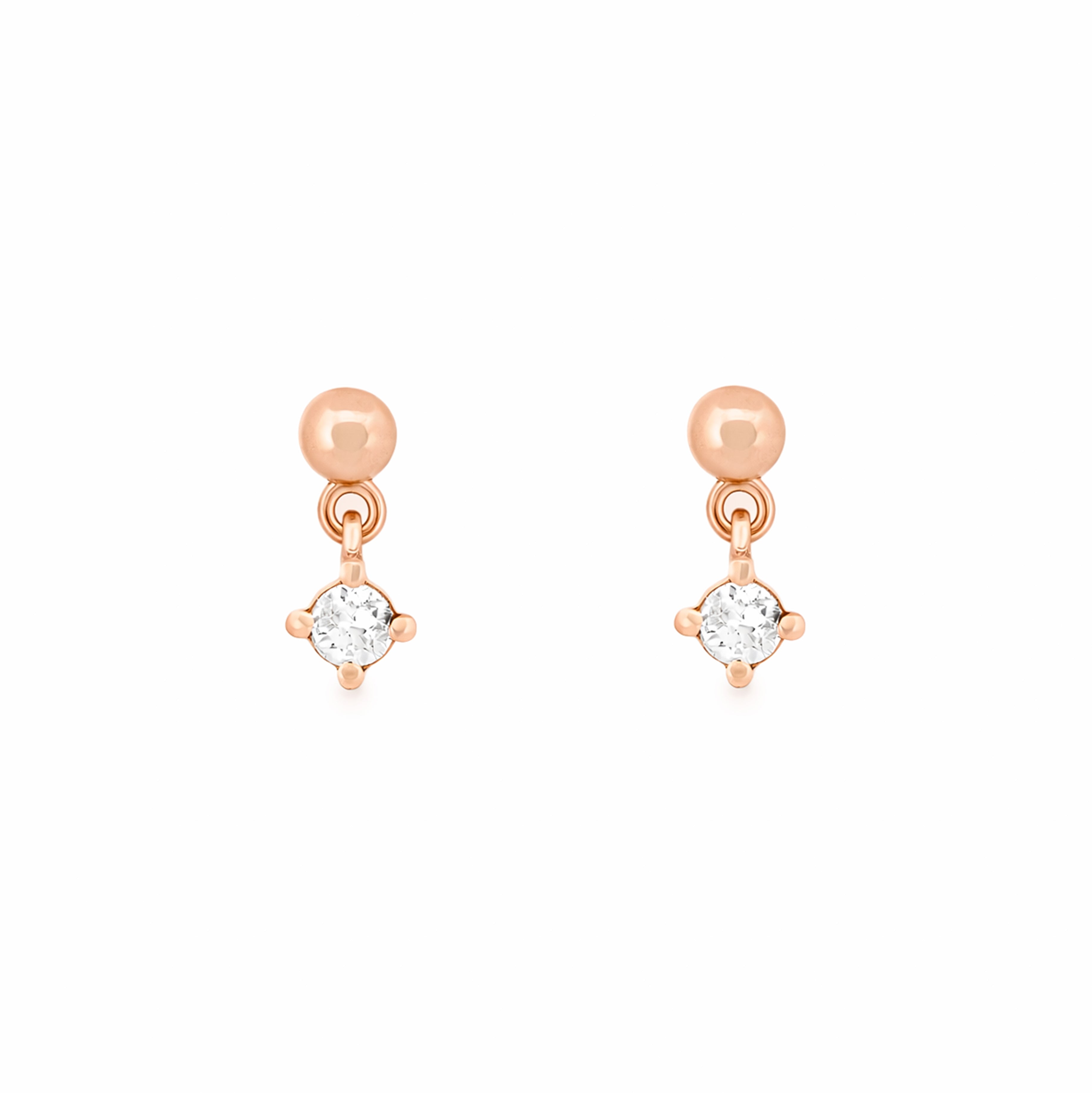 Rose gold earrings with round diamonds on a white background