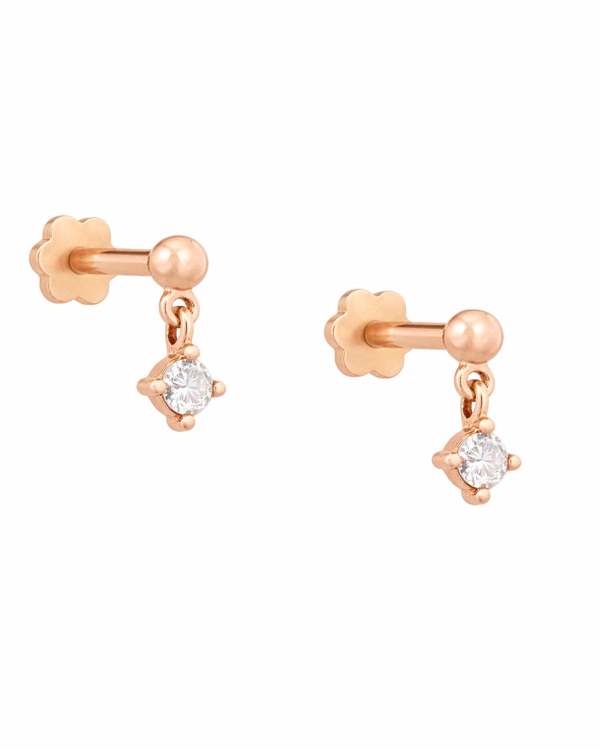 Rose gold earrings with round diamonds on a white background
