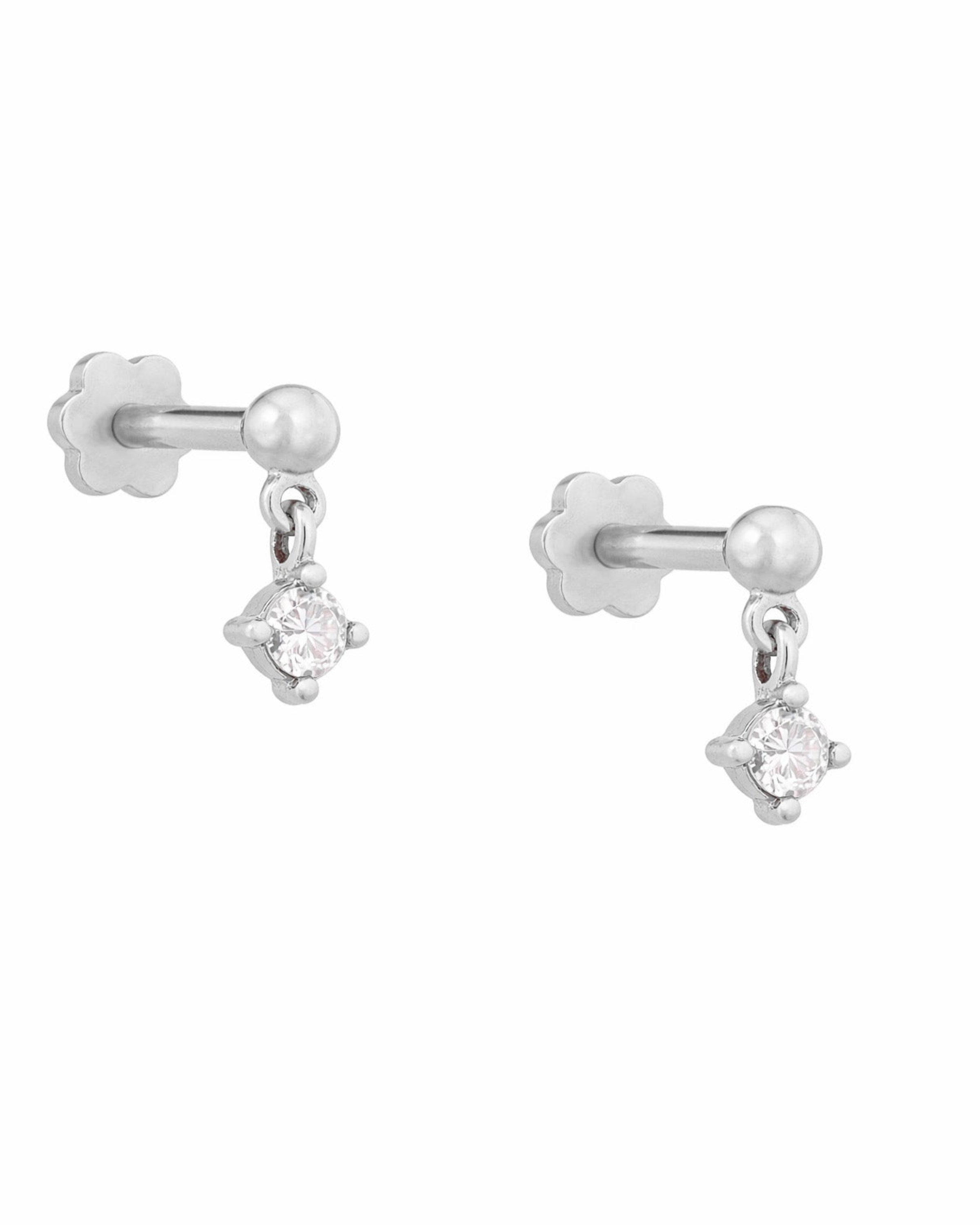 White gold earrings with round diamonds on a white background