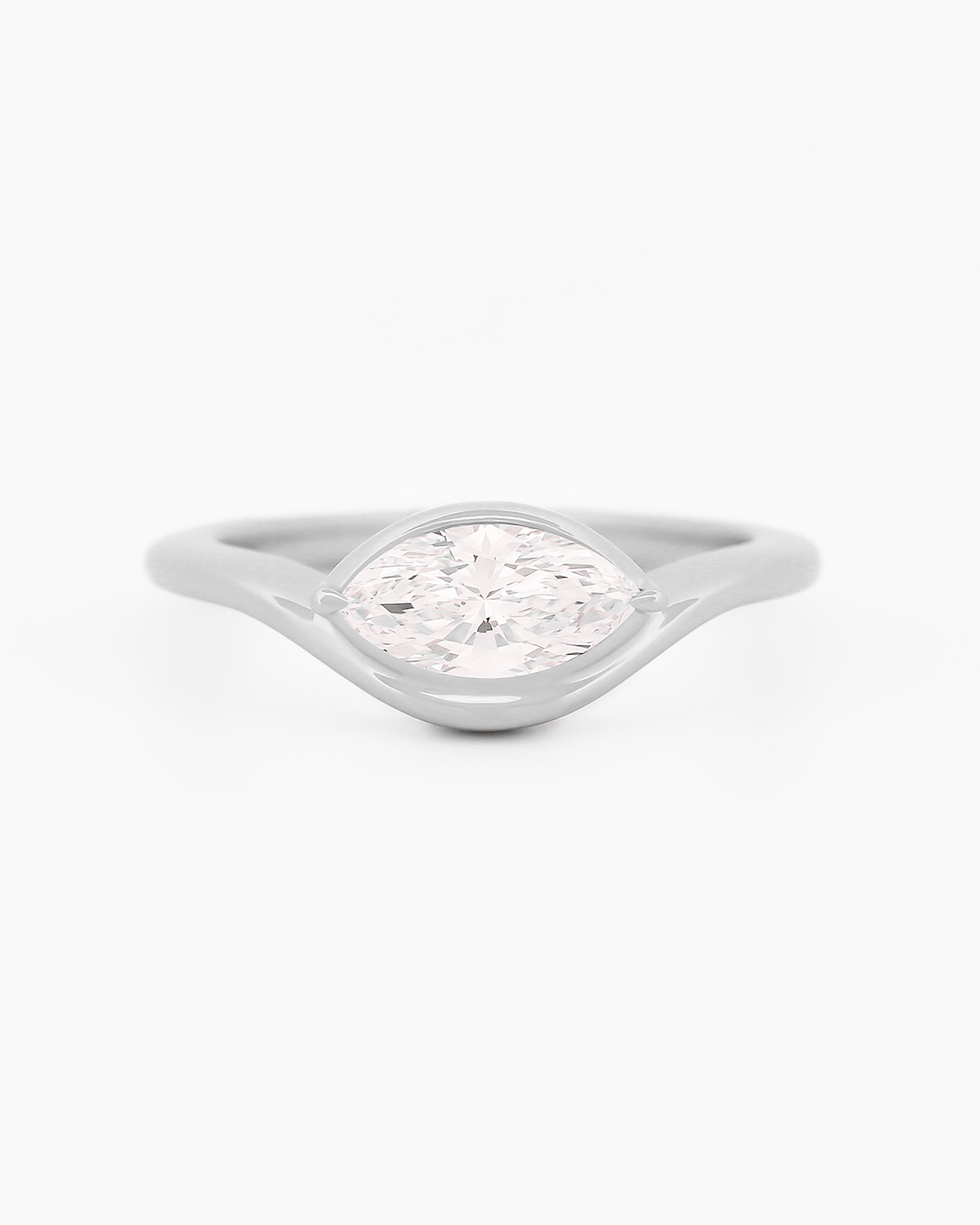 White gold solitaire ring with a marquise diamond on a white background.