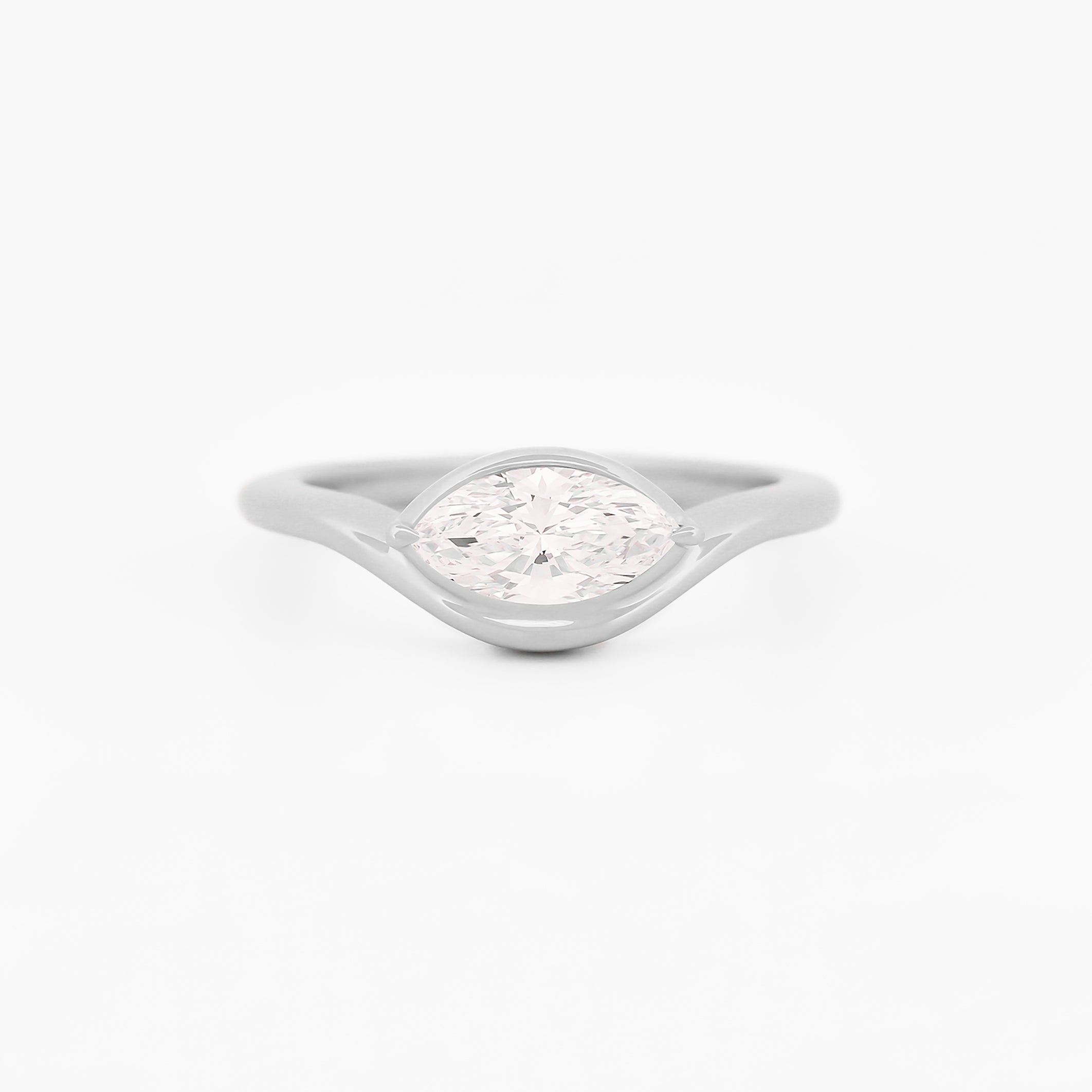 White gold solitaire ring with a marquise diamond on a white background.