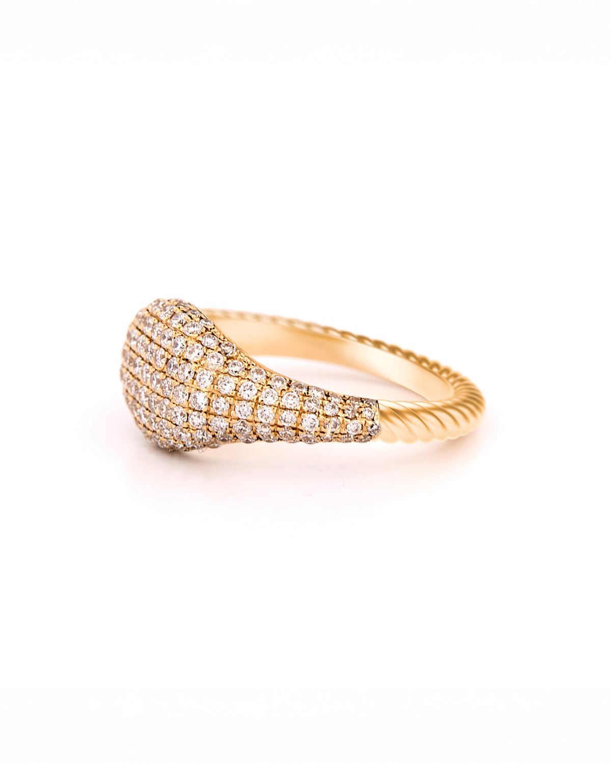 Gold ring with pave diamonds accents and a twisted gold band on a white background