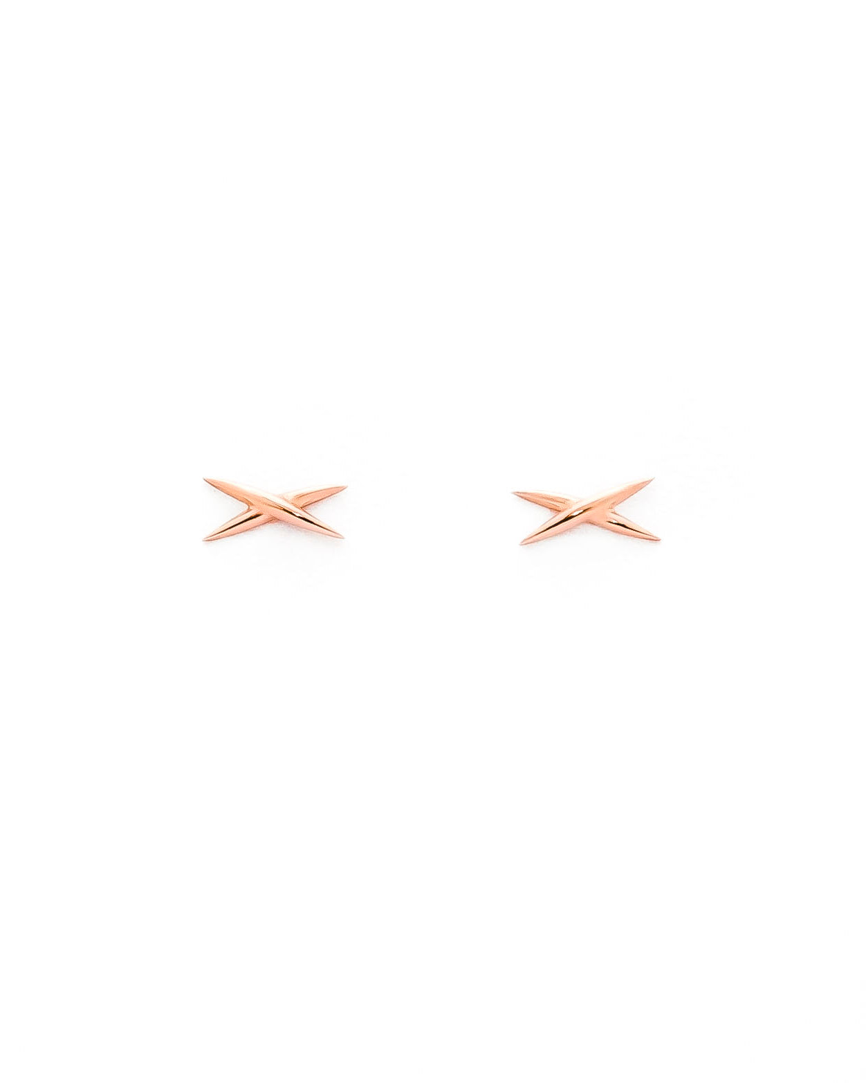 A pair of gold-colored stud earrings shaped like an X on a white background.