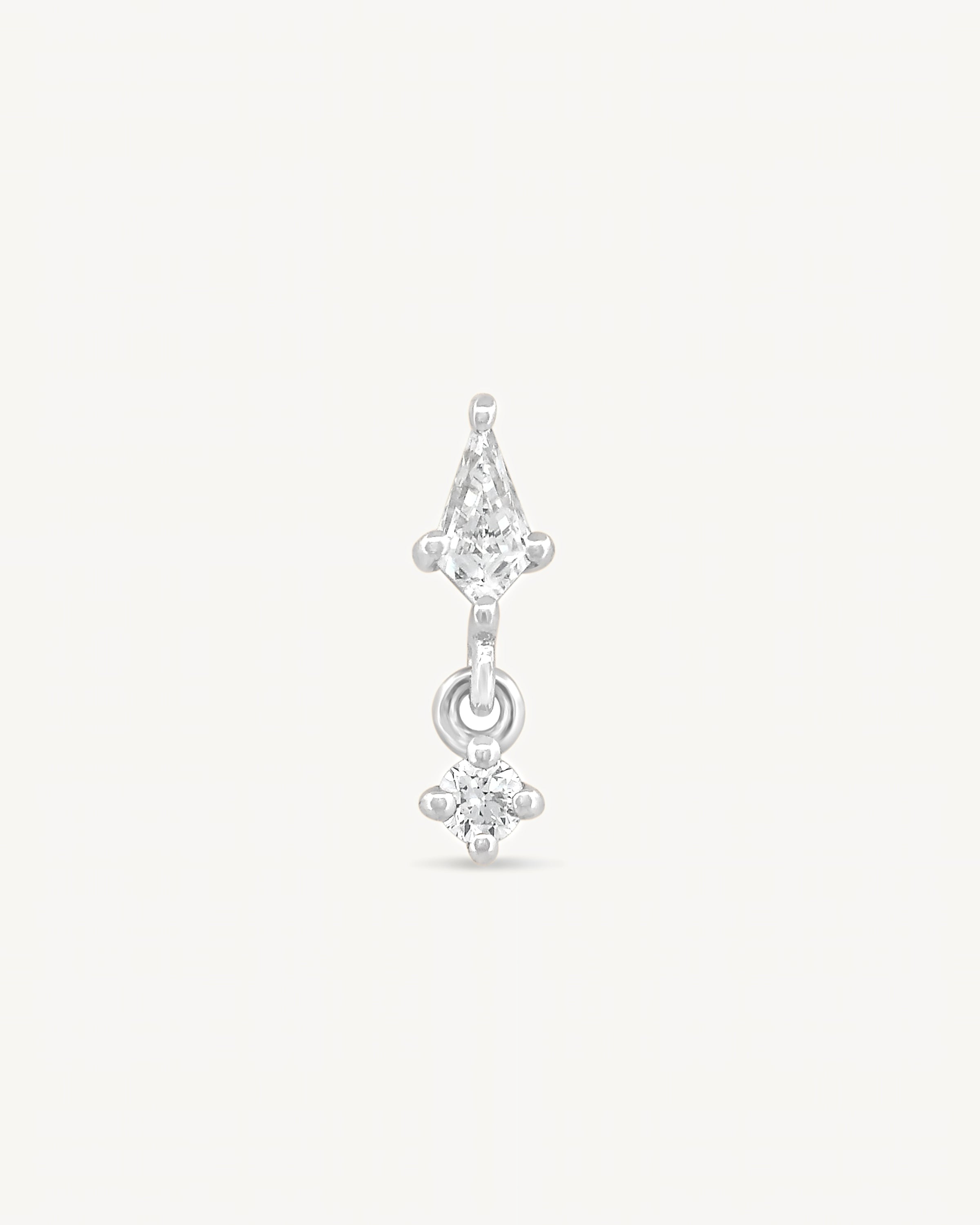 Kite and round diamonds stud earring with white gold on a light gray background