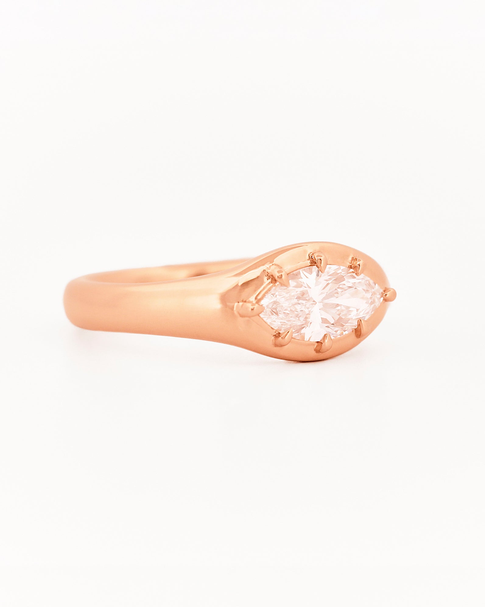 Signet Pinky marquise Diamond ring, in rose gold, on a with a white background