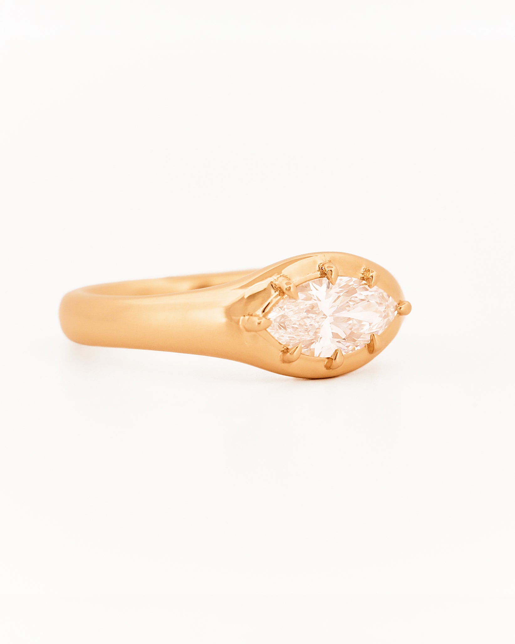 Signet Pinky Marquise Diamond ring, in yellow gold, on a with a white background