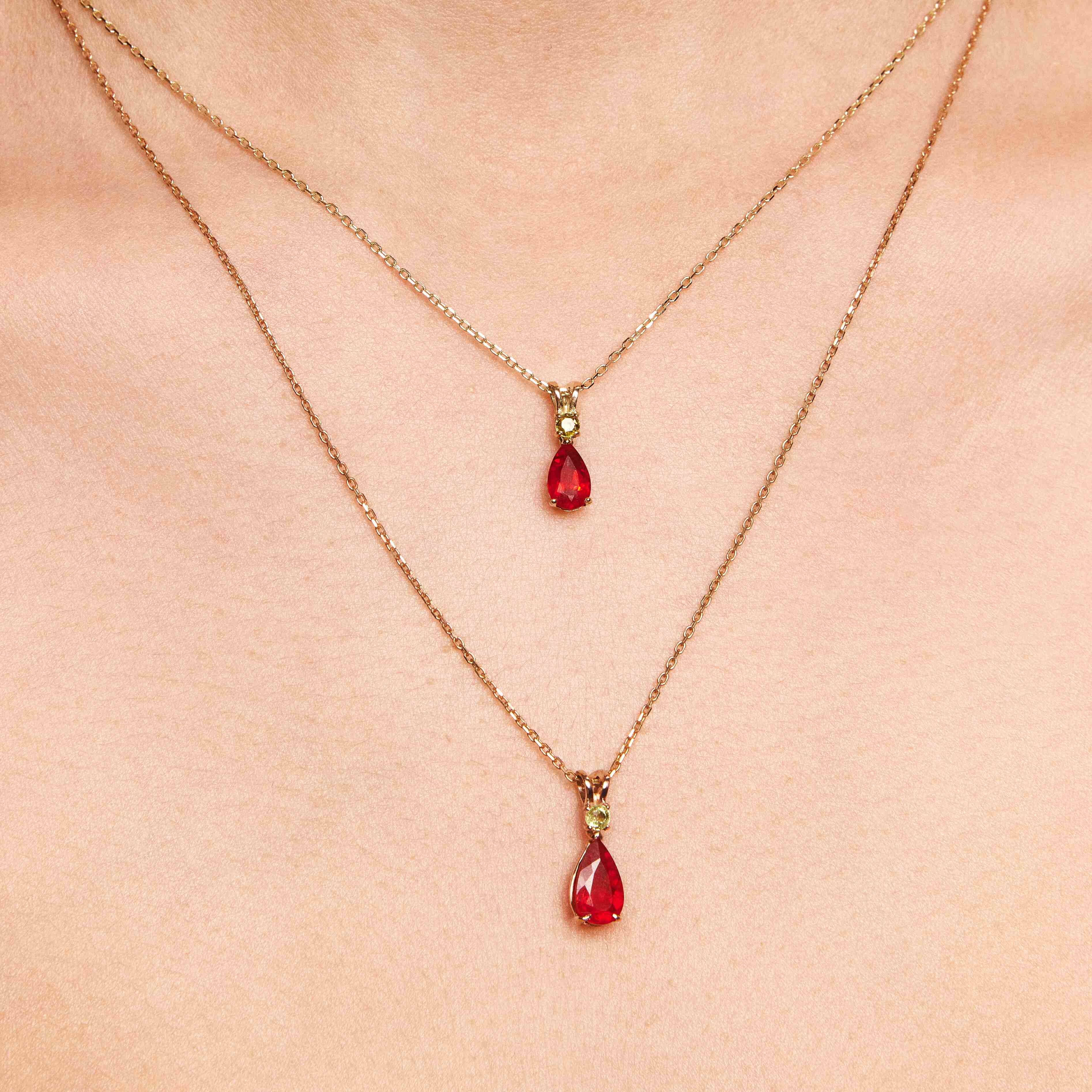 Mexican opal and red sapphire pendants with gren sapphire details on gold chains.