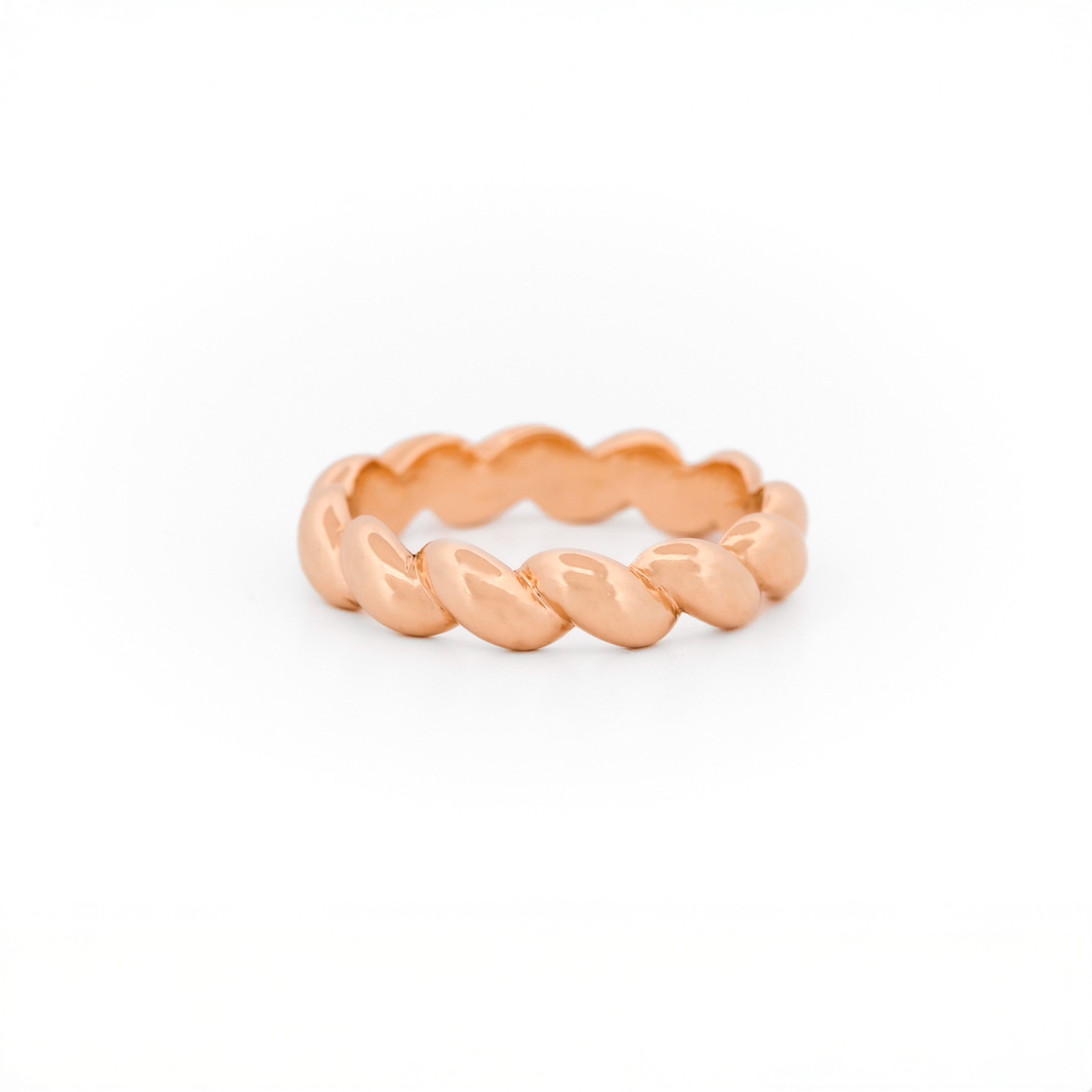 Rose Gold ring with a braided design on a white background