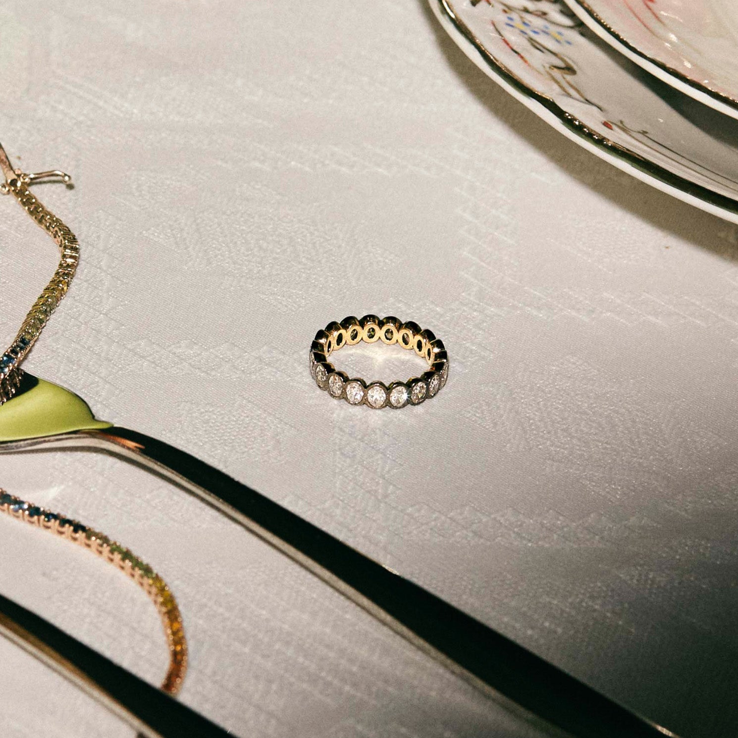 Gold ring with diamonds on a textured surface