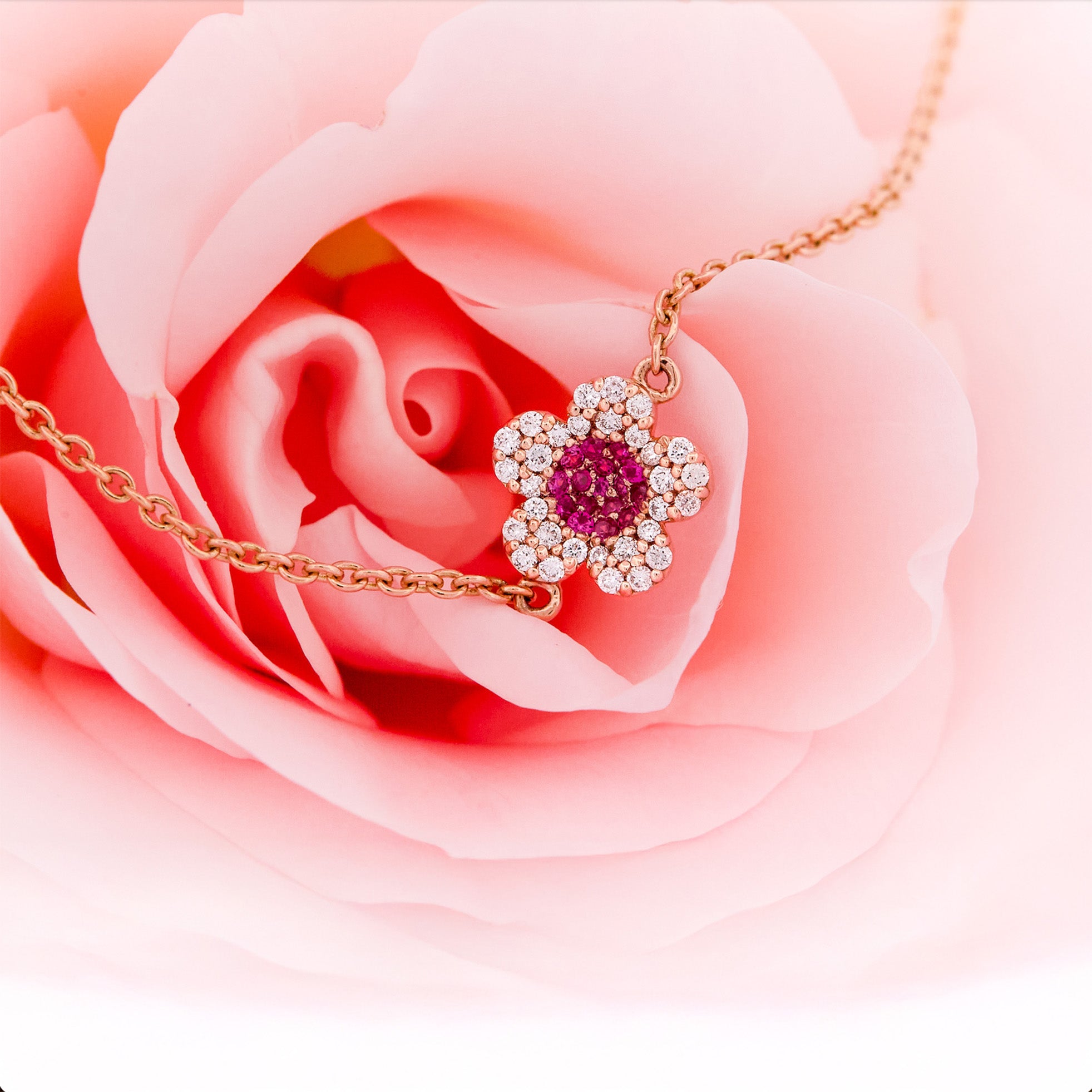 Rose gold bracelet with a ruby and diamonds flower on a rose flower