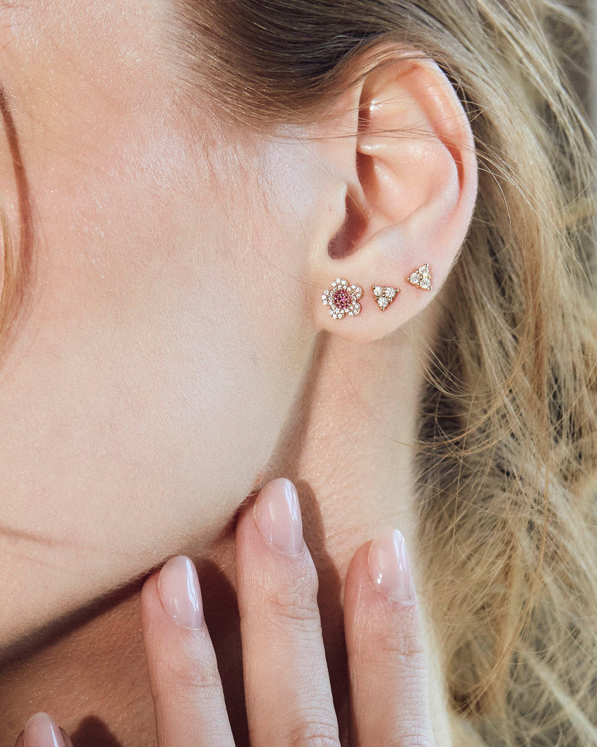 beautiful blossom flower earrings on model, diamond earrings simple arranged in a game of three dots.