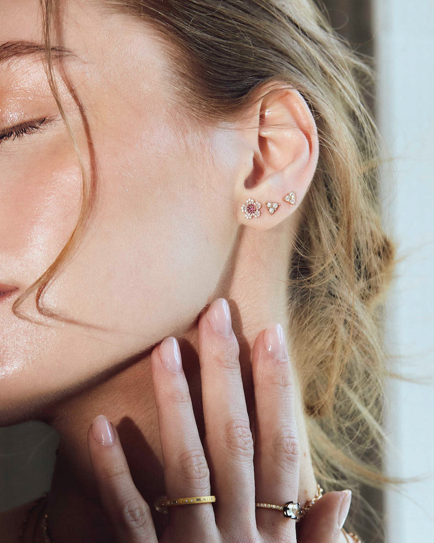 beautiful blossom flower earrings on model, diamond earrings simple arranged in a game of three dots.