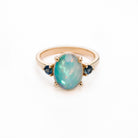 Vintage looking Ethiopian Opal ring with blue sapphire side stones on white background. Inel vintage cu opal etiopian și safire albastre pe fundal alb.