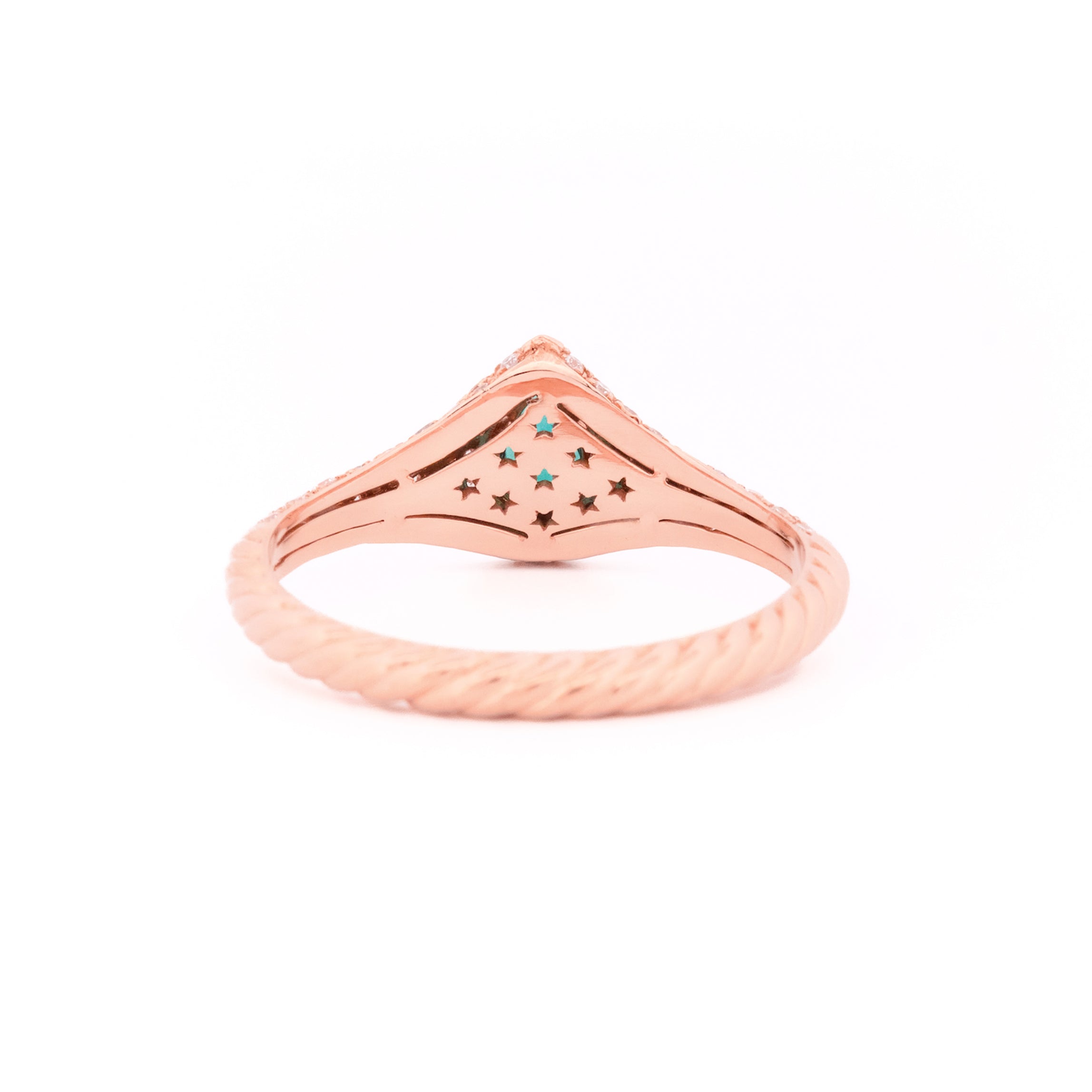 Gold signet ring with a emerald teardrop gemstone and pave diamonds on a white background