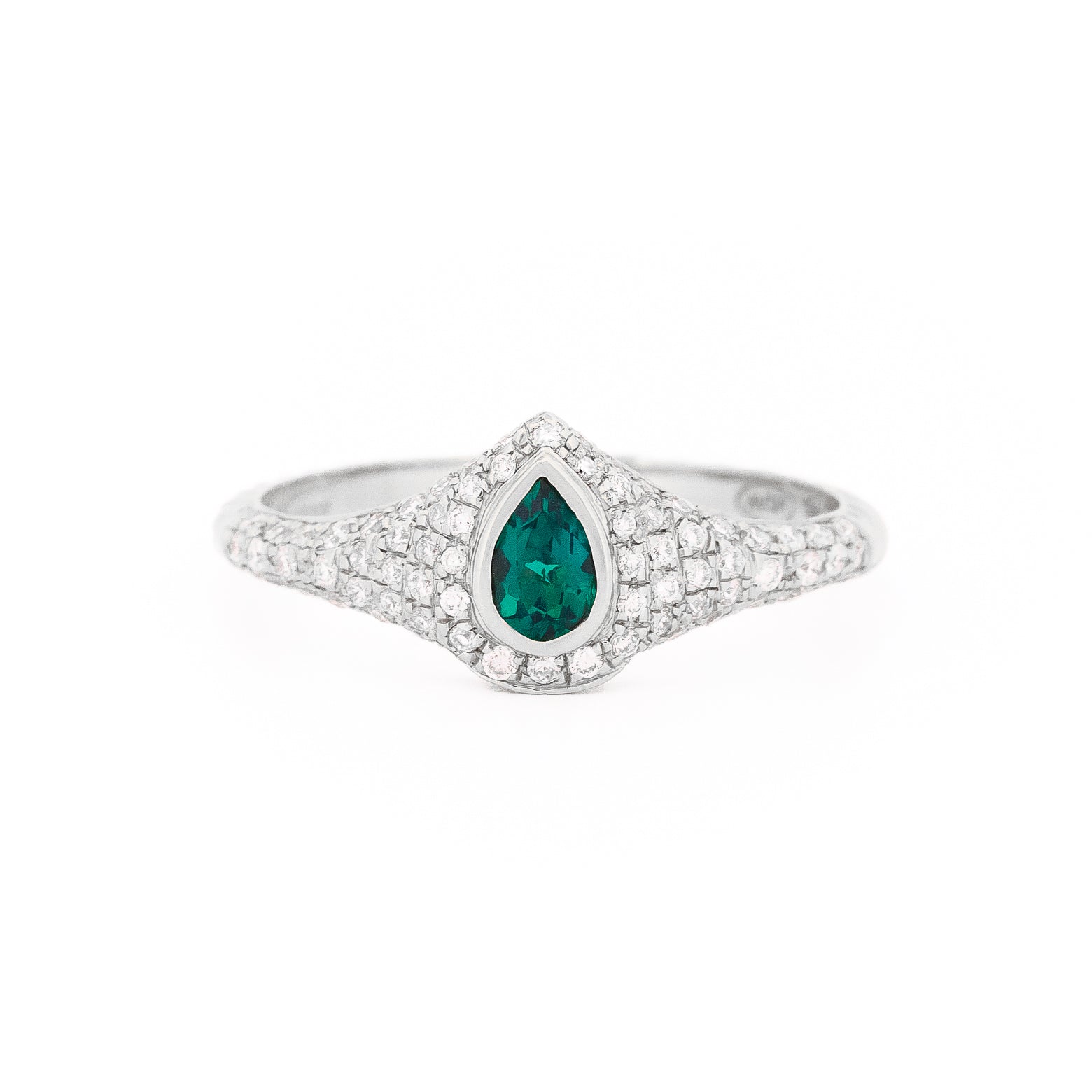 Gold signet ring with a emerald teardrop gemstone and pave diamonds on a white background