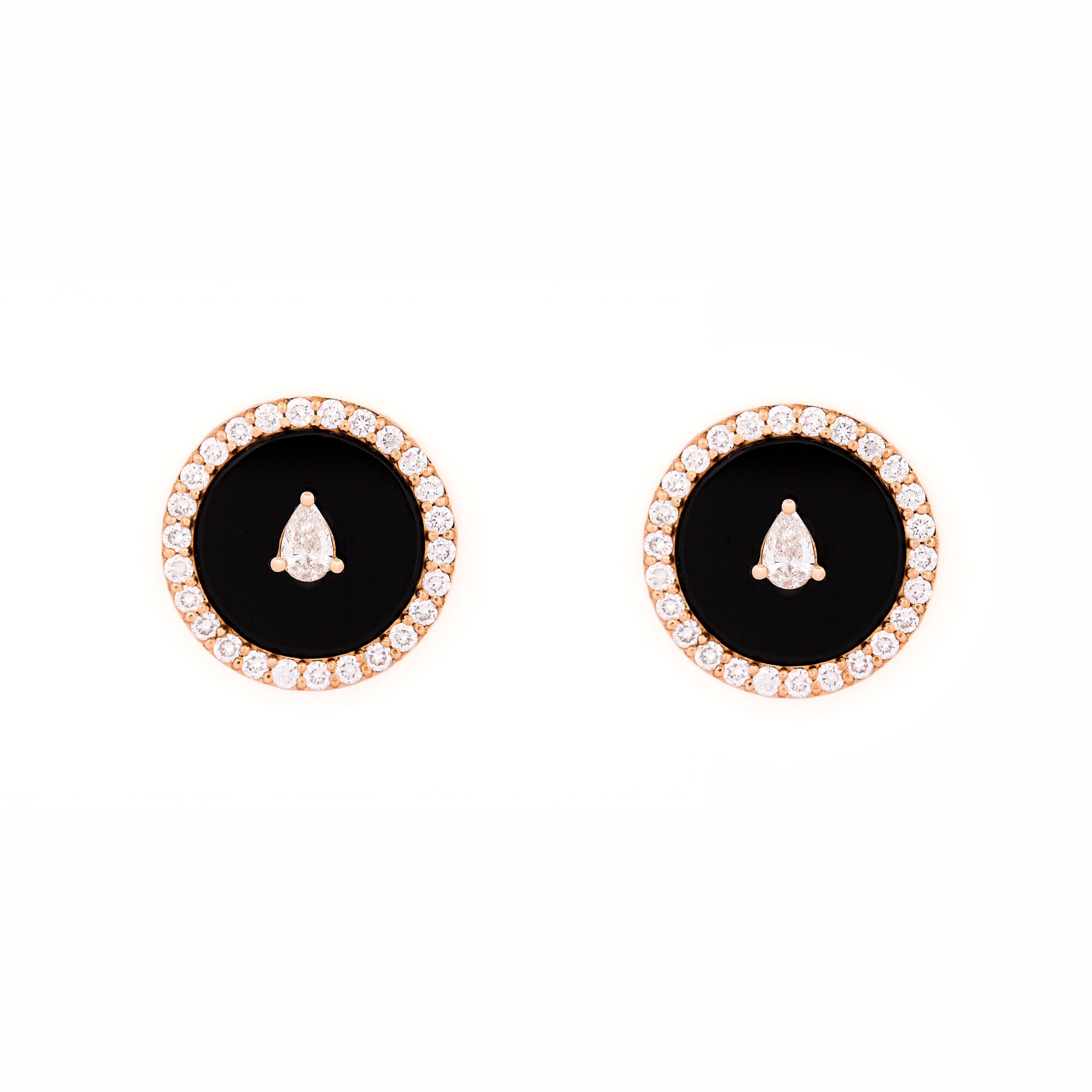 Pair of earrings with black onyx center stone and teardrop and round shape diamonds accents on a white background