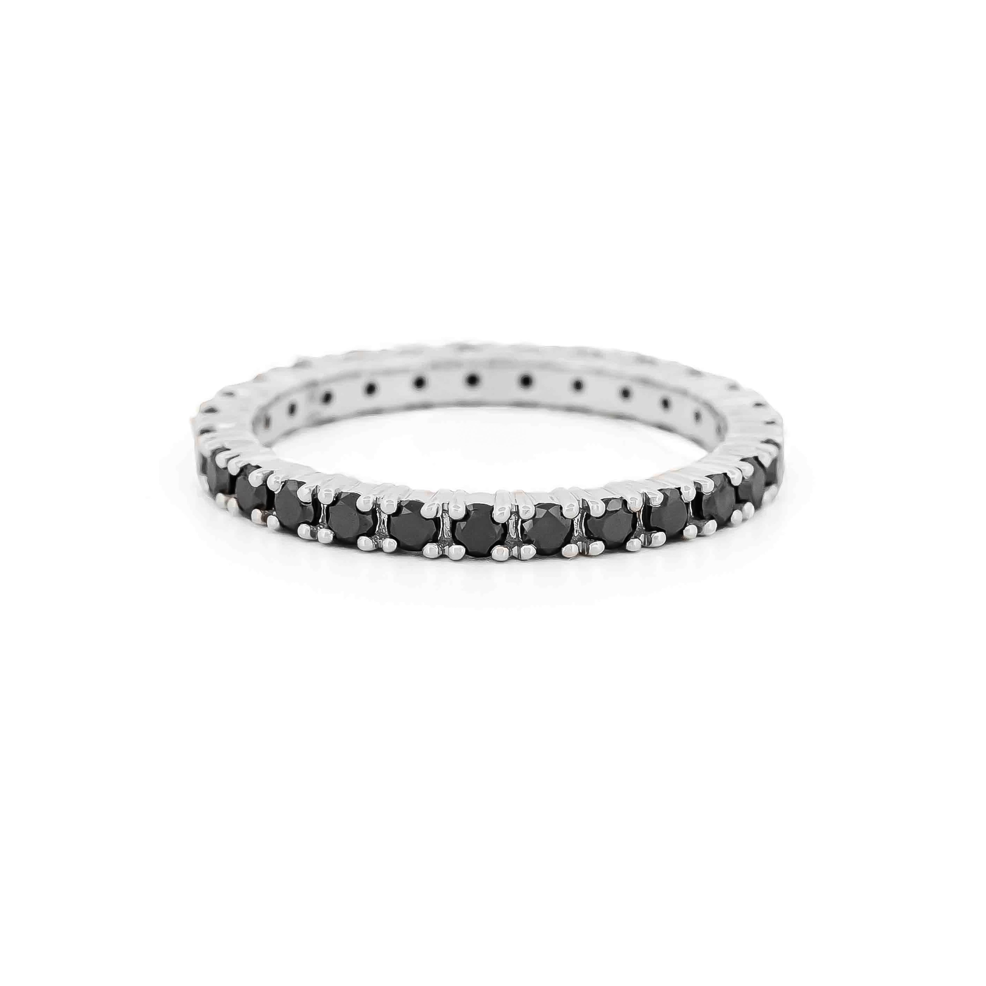 white gold eternity ring with black diamonds on a white background