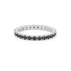 white gold ring with black diamonds on a white background