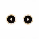 Pair of earrings with black onyx center stone and diamond marquise and round shape accents on a white background
