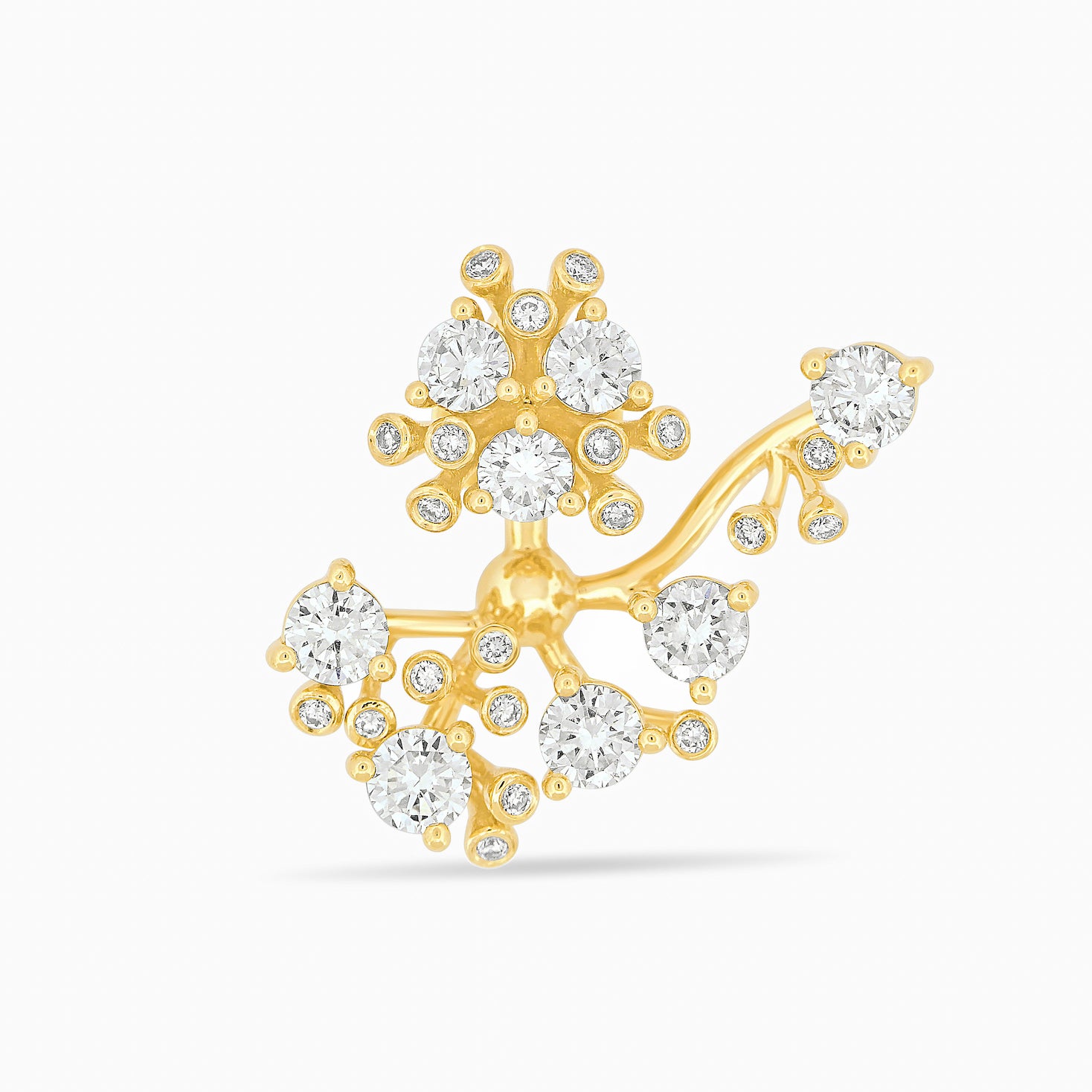 Gold and diamond bloom earring against a white background.