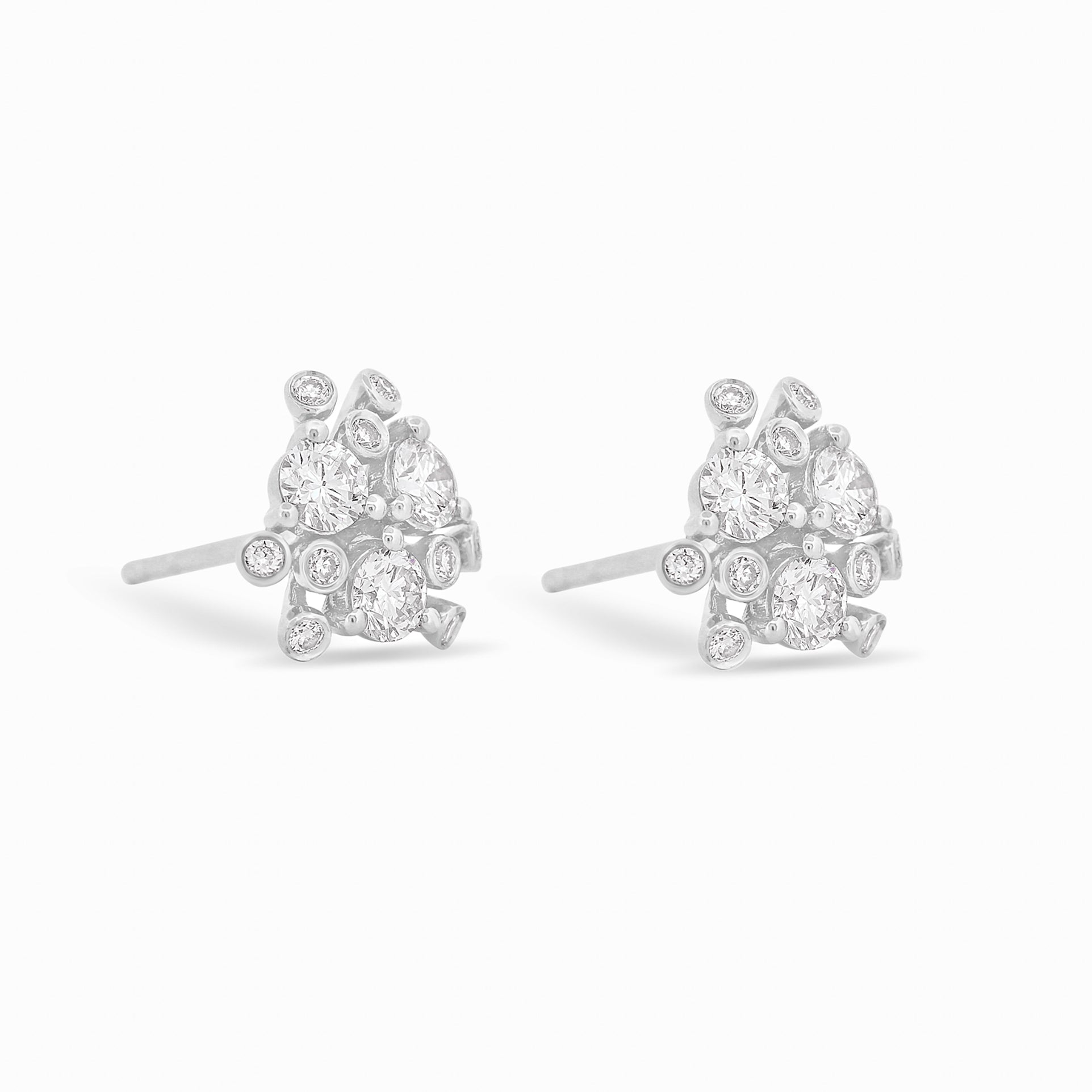 Gold and diamond bloom earrings against a white background.