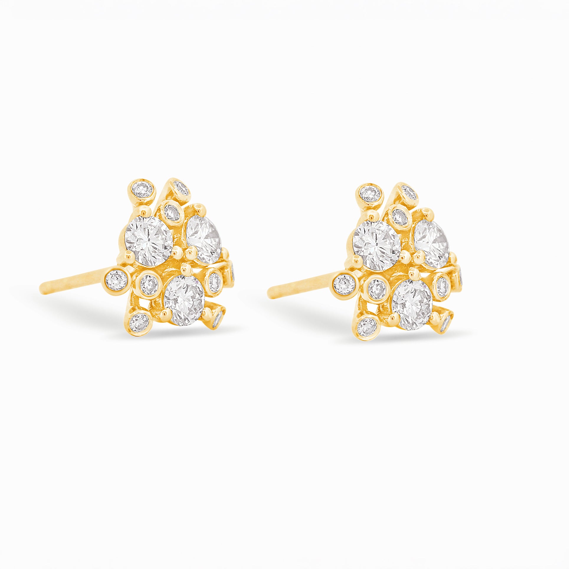 Gold and diamond earrings on a white background.
