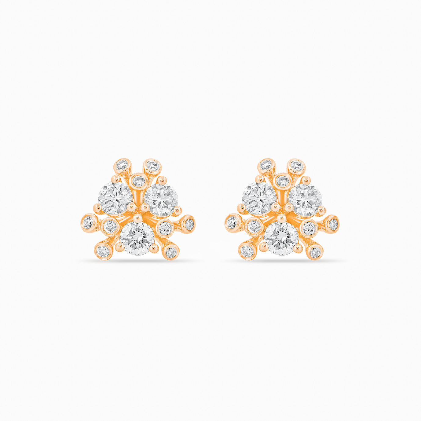 Gold and diamond earrings on a white background.