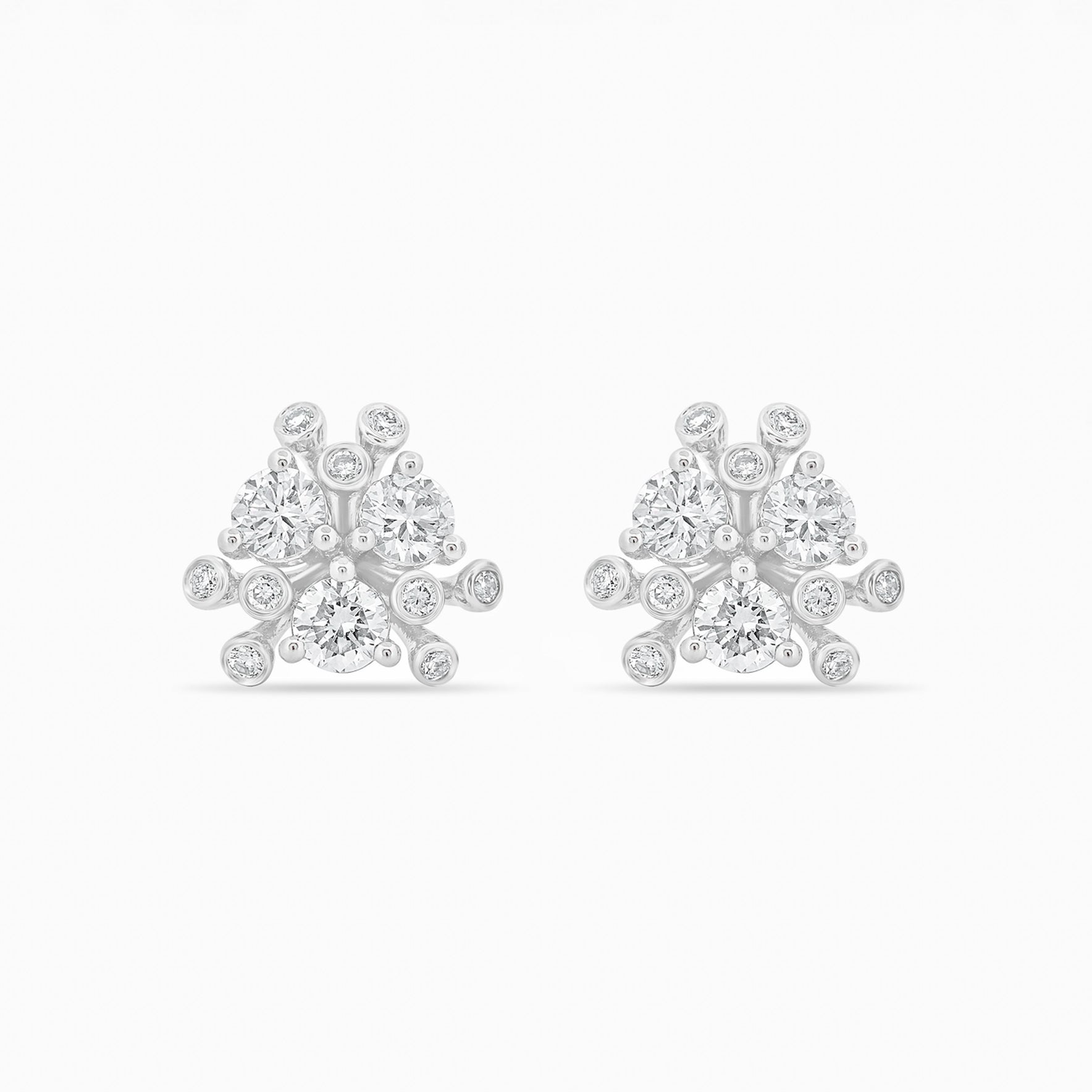 Gold and diamond earrings on a white background.