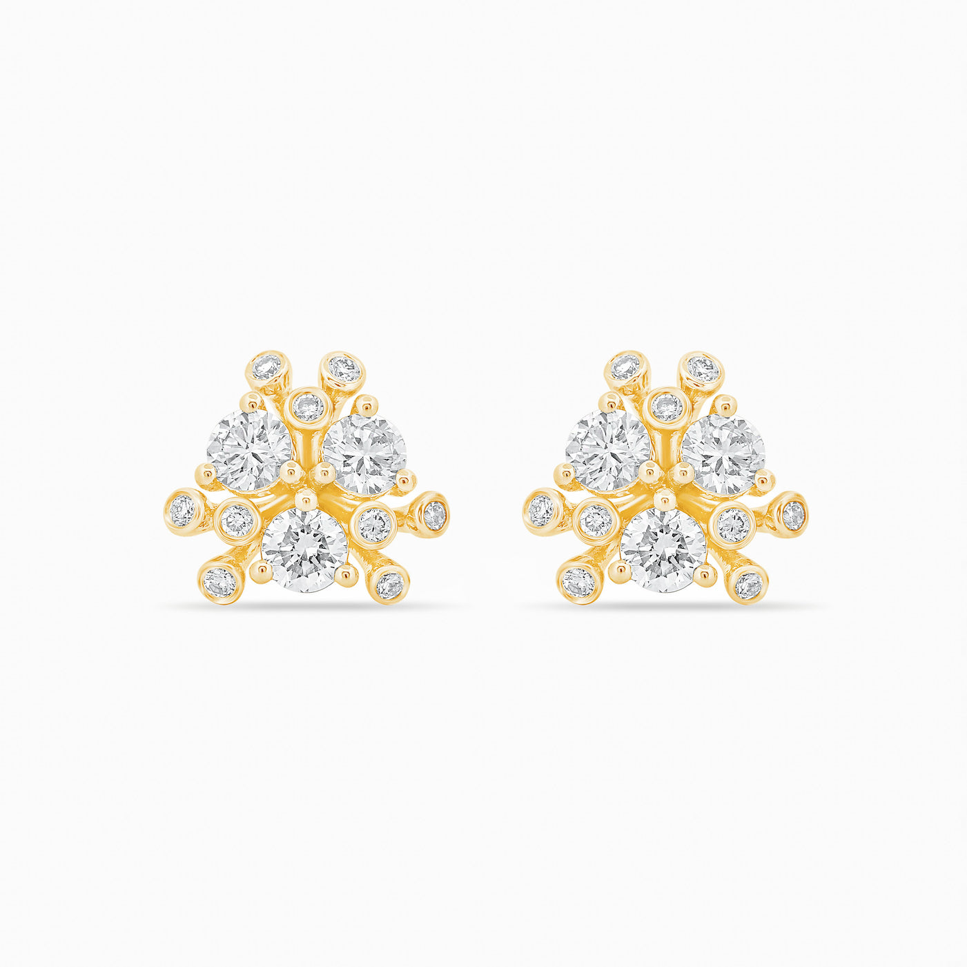 Gold and diamond earrings on a white background.