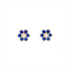 Pair of floral earrings with blue sapphires and diamonds and yellow gold accents on a white background