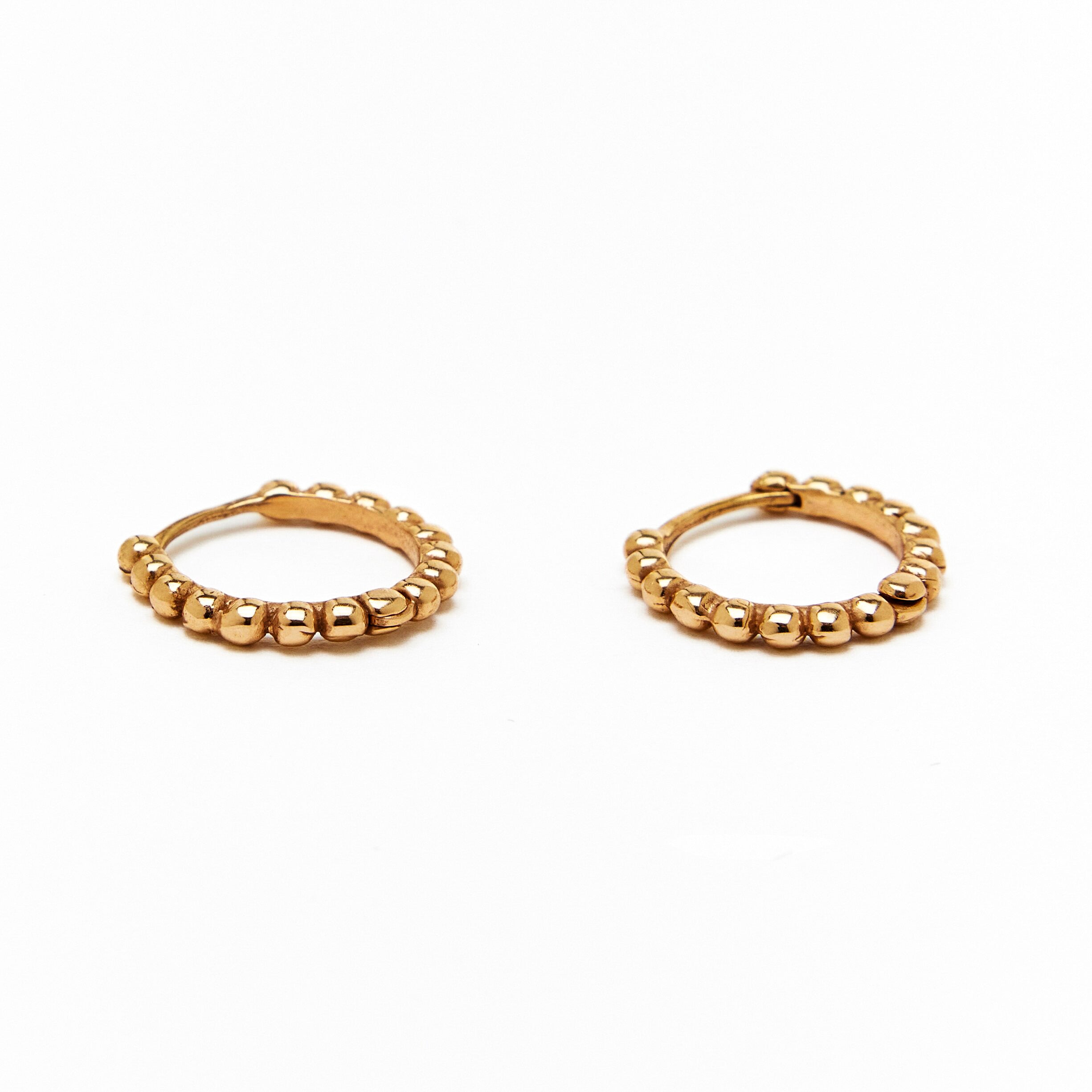 A pair of gold hoop earrings with a beaded design, made to order.