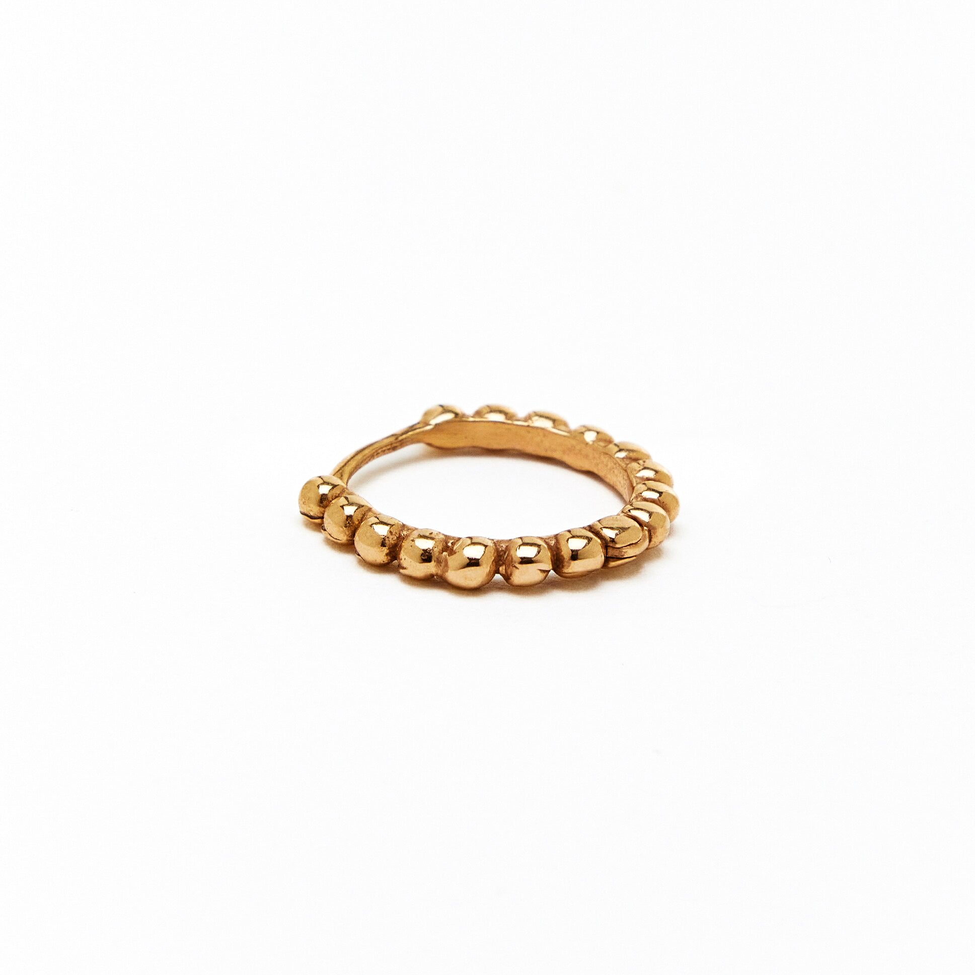 a gold hoop earring with a beaded design, made to order.