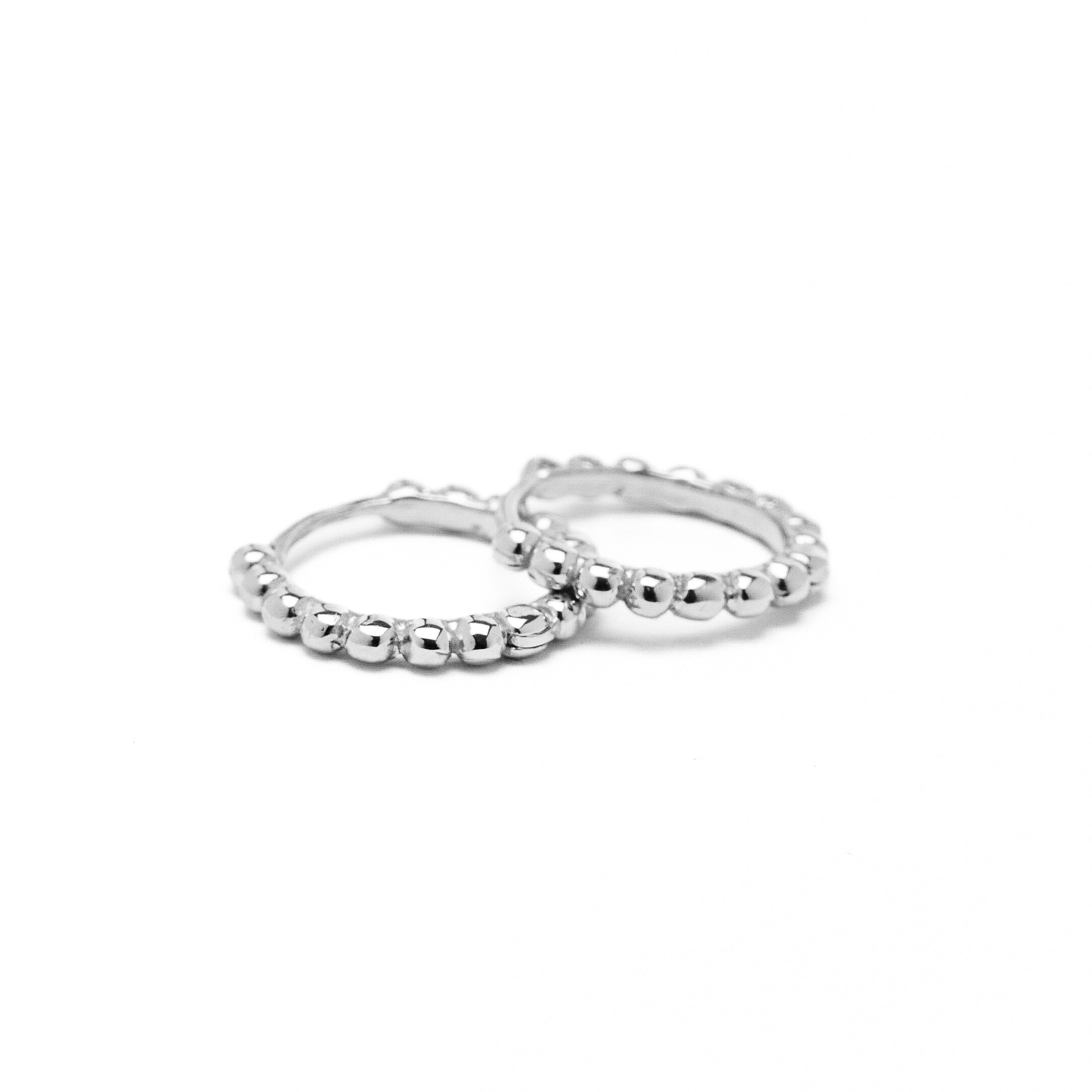 A pair of gold hoop earrings with a beaded design, made to order.