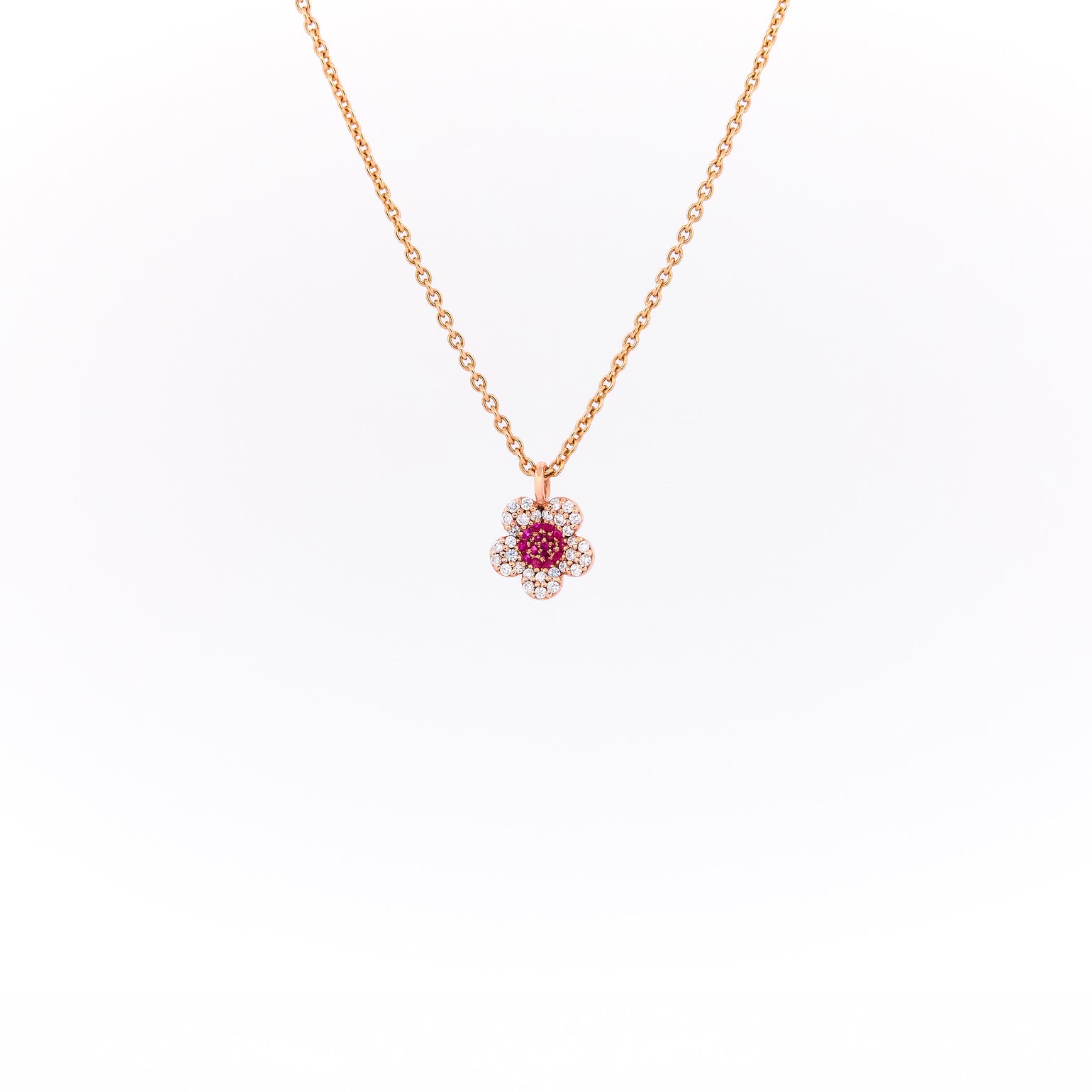 Rose gold necklace with a floral pendant on a white background