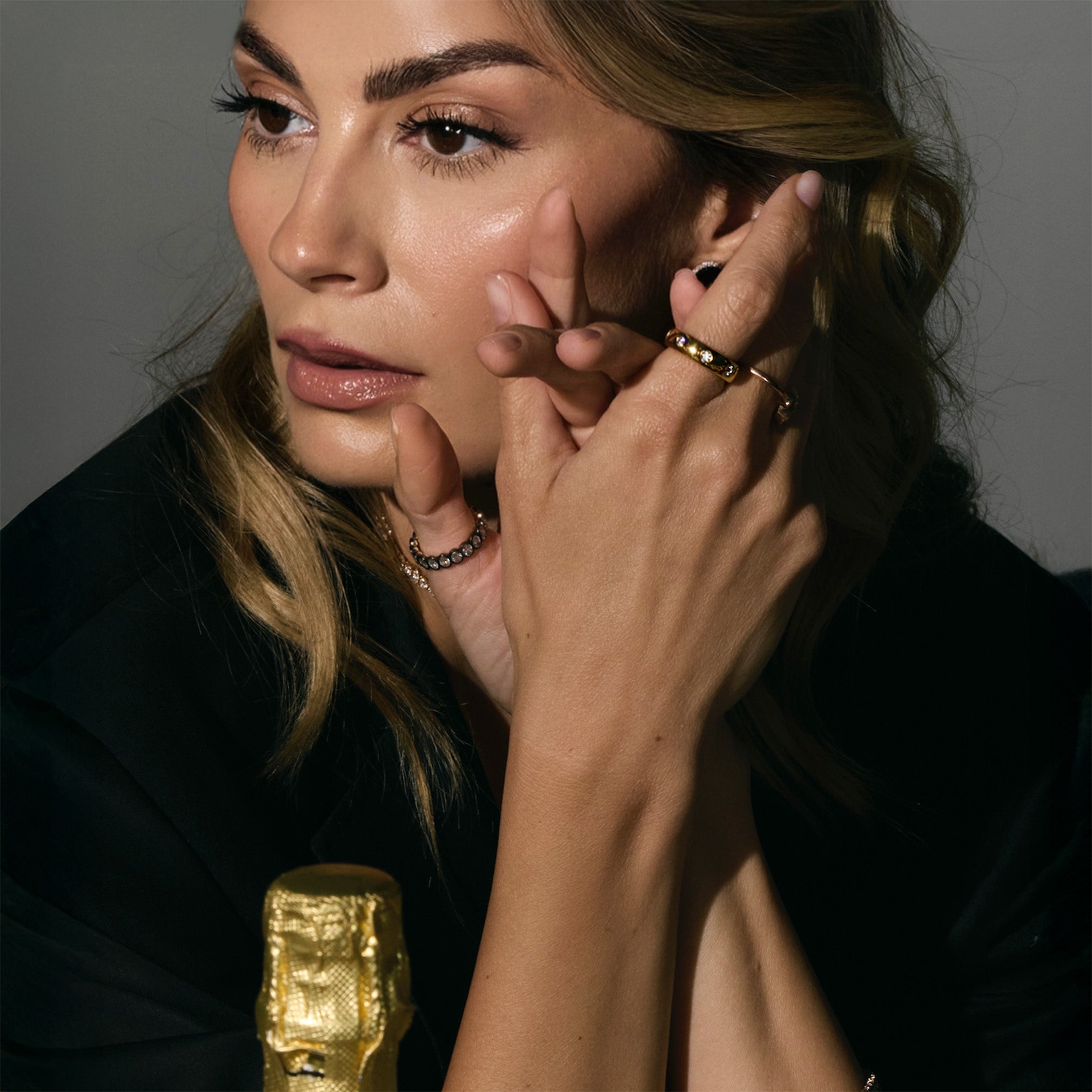 Woman wearing expensive gold and diamonds ring.