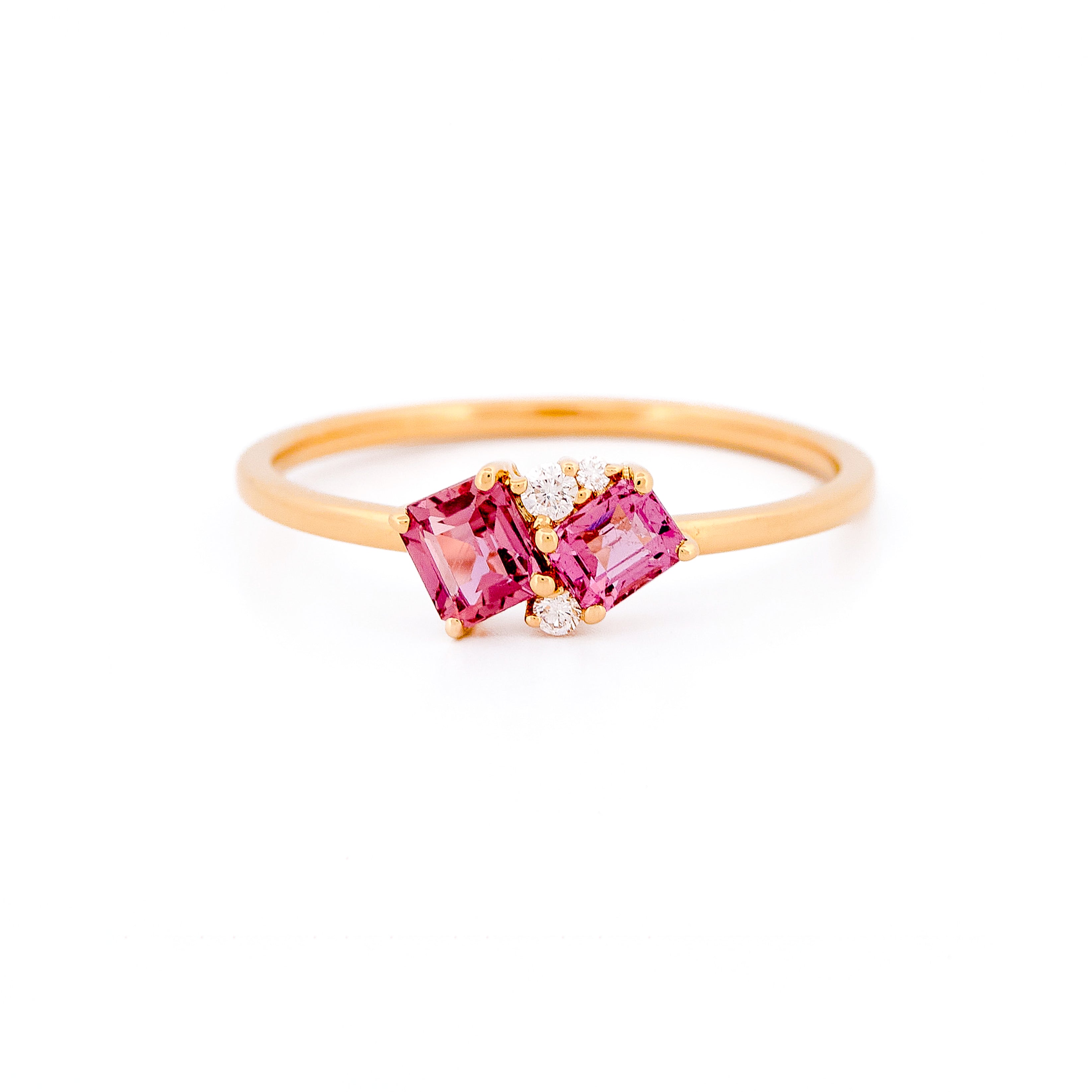 Gold ring with two pink sapphires and diamonds accents on a white background