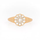 Yellow gold ring with diamond cluster daisy flower on a white background