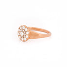 Rose gold ring with diamond cluster on a white background